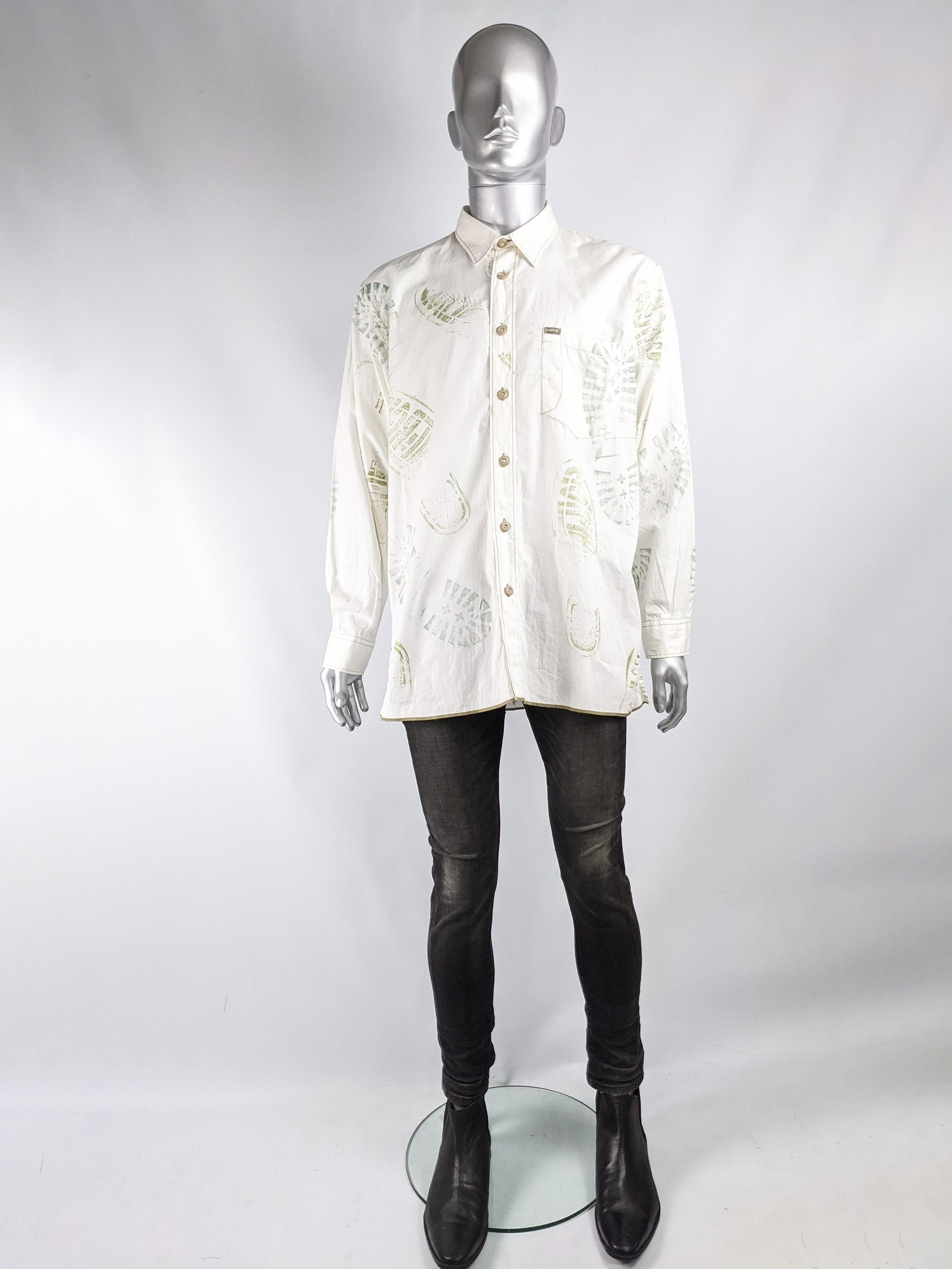An amazing vintage shirt from the 90s by Italian cult label, Energie. In an off white cotton with an intentionally distressed look with unusual stitching, spots in places, a raw hem and an incredible splattered boot print throughout. 

Size: Marked