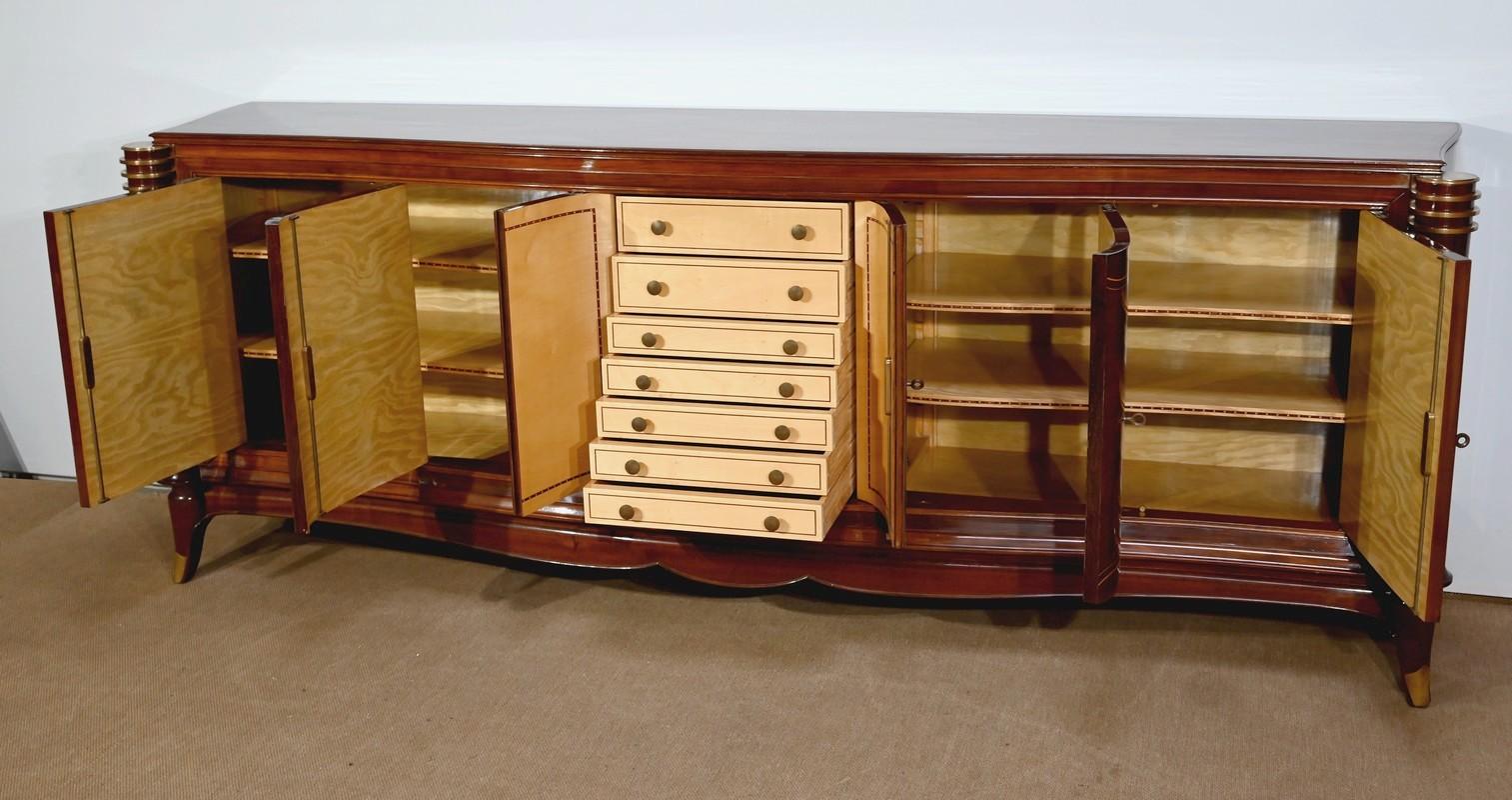 Rio rosewood, rosewood, and sycamore veneer sideboard, attributed to the renowned French designer Jules Leleu (1883–1961).
It opens on the front with five swing doors mounted on bricks, inlaid with diamonds, lemonwood stringing, mother-of-pearl