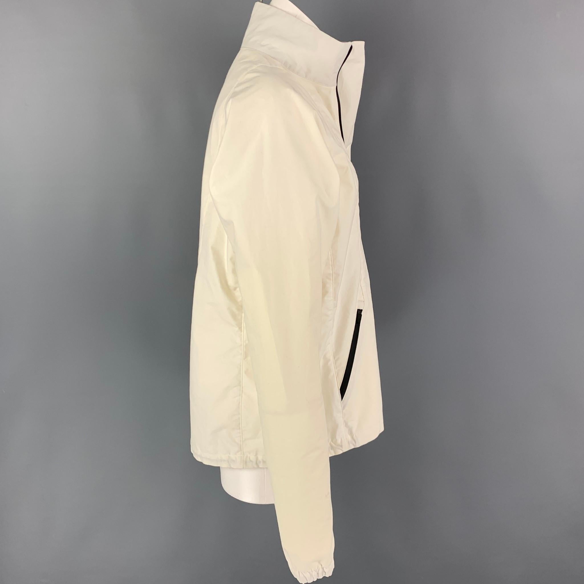 ENFIN LEVE jacket comes in a cream cotton featuring a water repellent design, high collar, black zippers, pocket zippers, and a half zip up closure. 

Very Good Pre-Owned Condition.
Marked: M
Original Retail Price: $740.00

Measurements:

Shoulder: