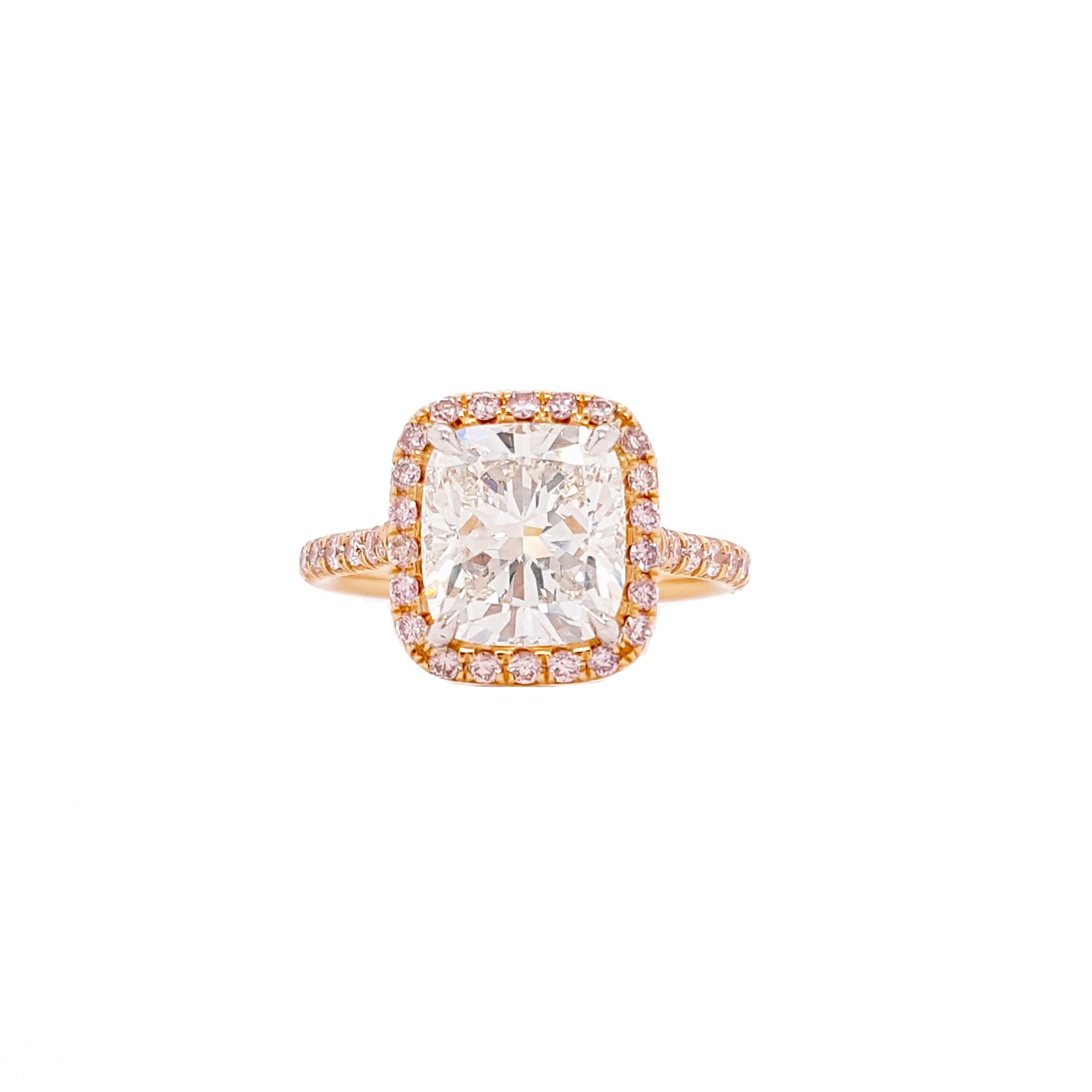 Engagement ring style showcasing a 3.5 carat cushion cut diamond certified by GIA as I color, VS2 clarity. The classic design brings out the beauty of the center stone with the surrounding 42 round pink diamonds, set in a polished 18k Rose gold