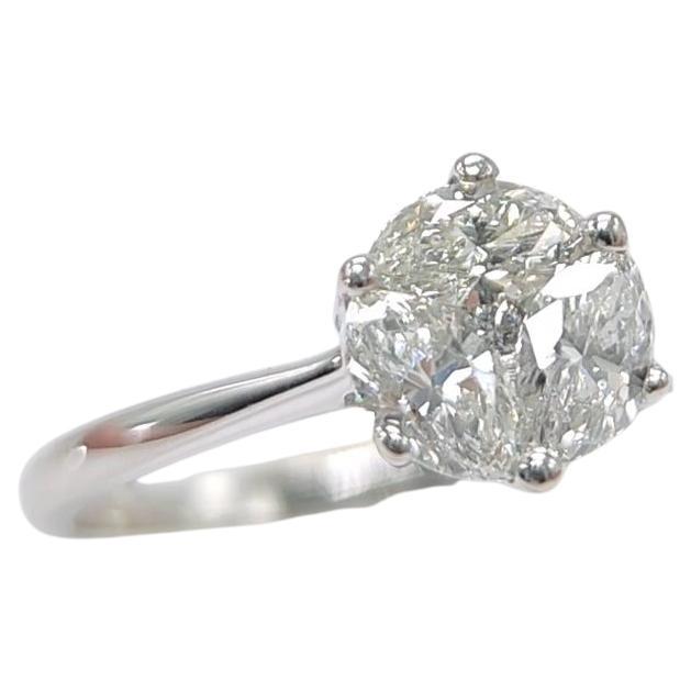 This cluster set diamond engagement ring is skillfully handcrafted with several small diamonds to create the look of a one-carat solitaire - whilst only featuring 0.50 carats in total. The setting not only provides eye-catching brilliance but also