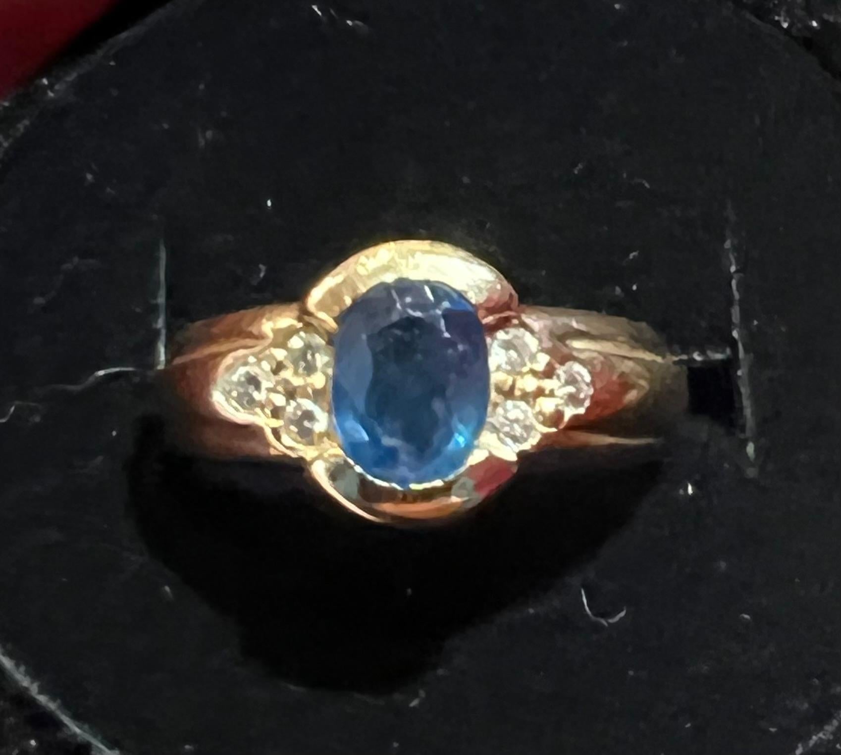 Women's or Men's Engagement Ring in 18 Carat Gold Set with a Sapphire Surrounded by Diamonds