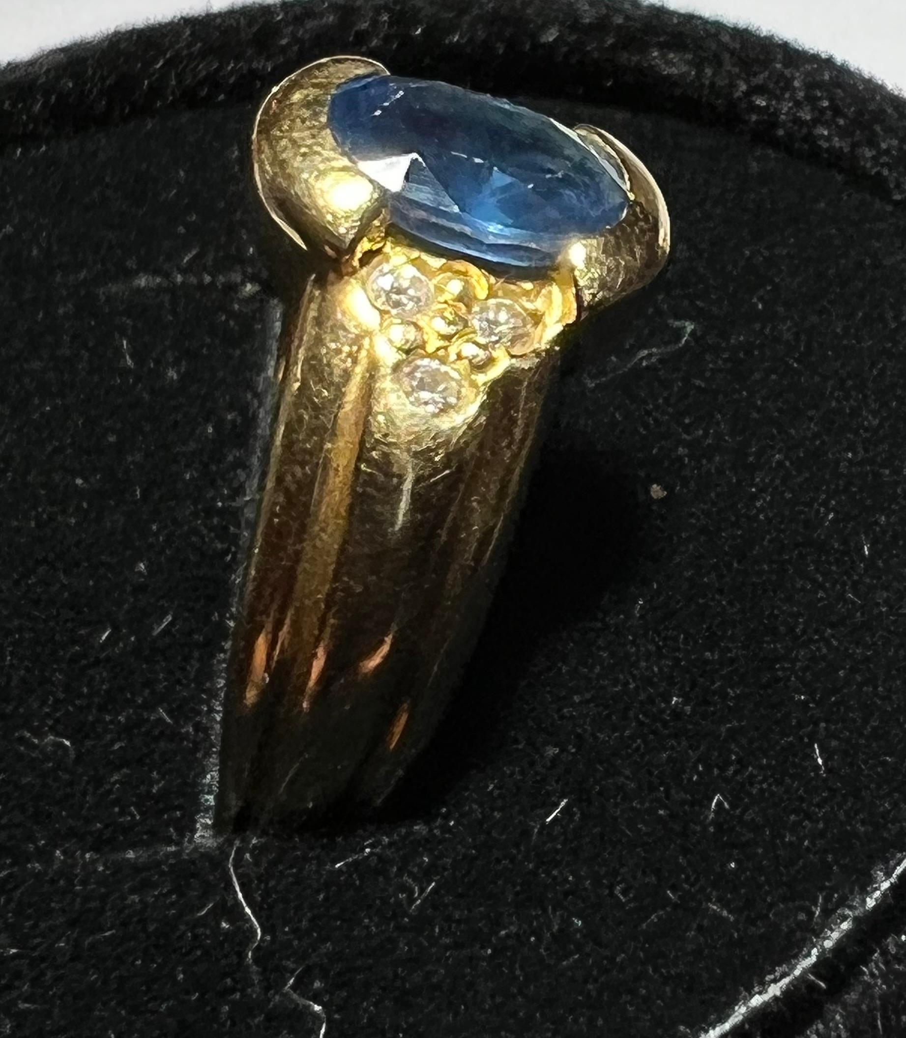Engagement Ring in 18 Carat Gold Set with a Sapphire Surrounded by Diamonds 1