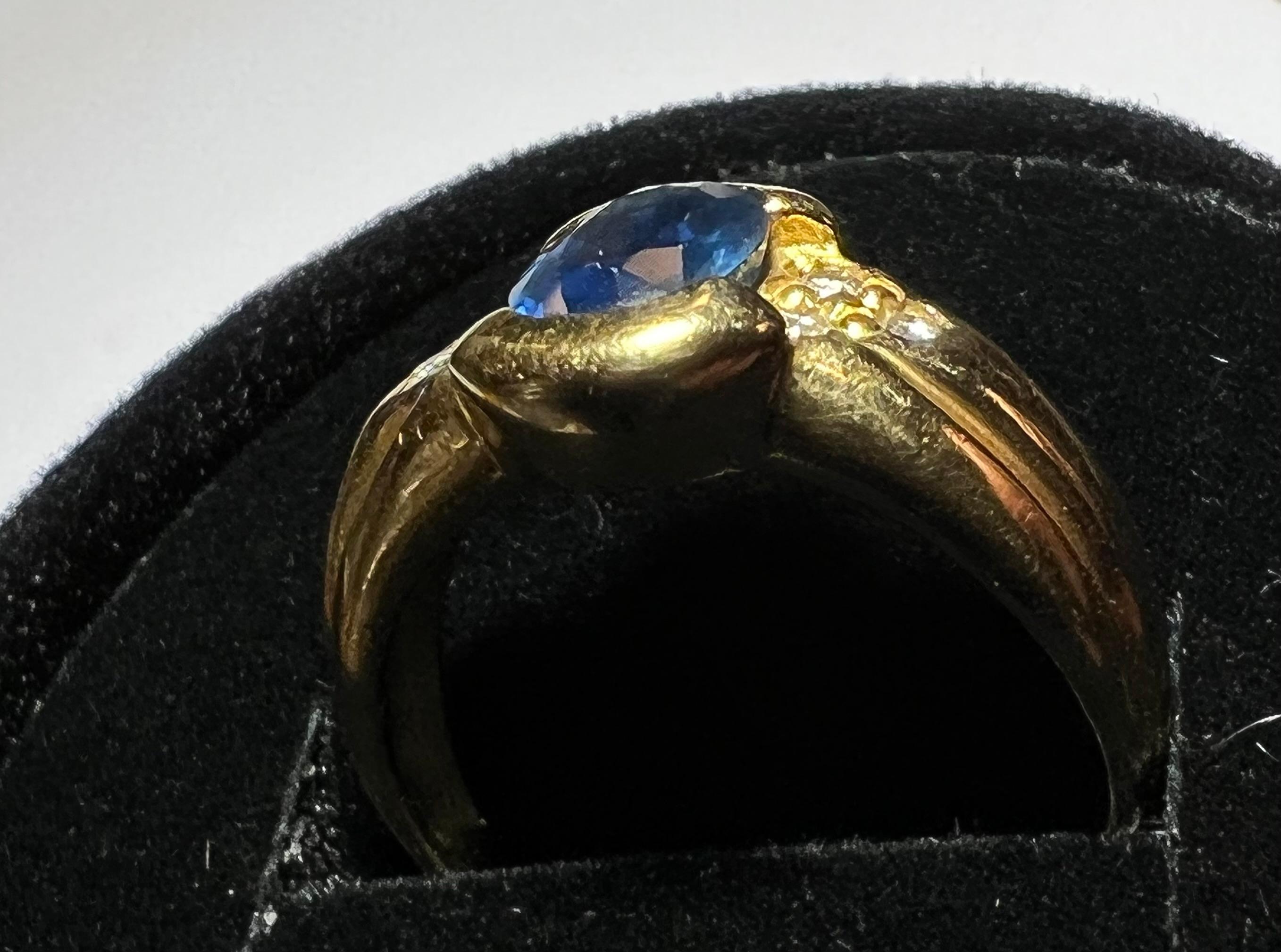 Engagement Ring in 18 Carat Gold Set with a Sapphire Surrounded by Diamonds 2