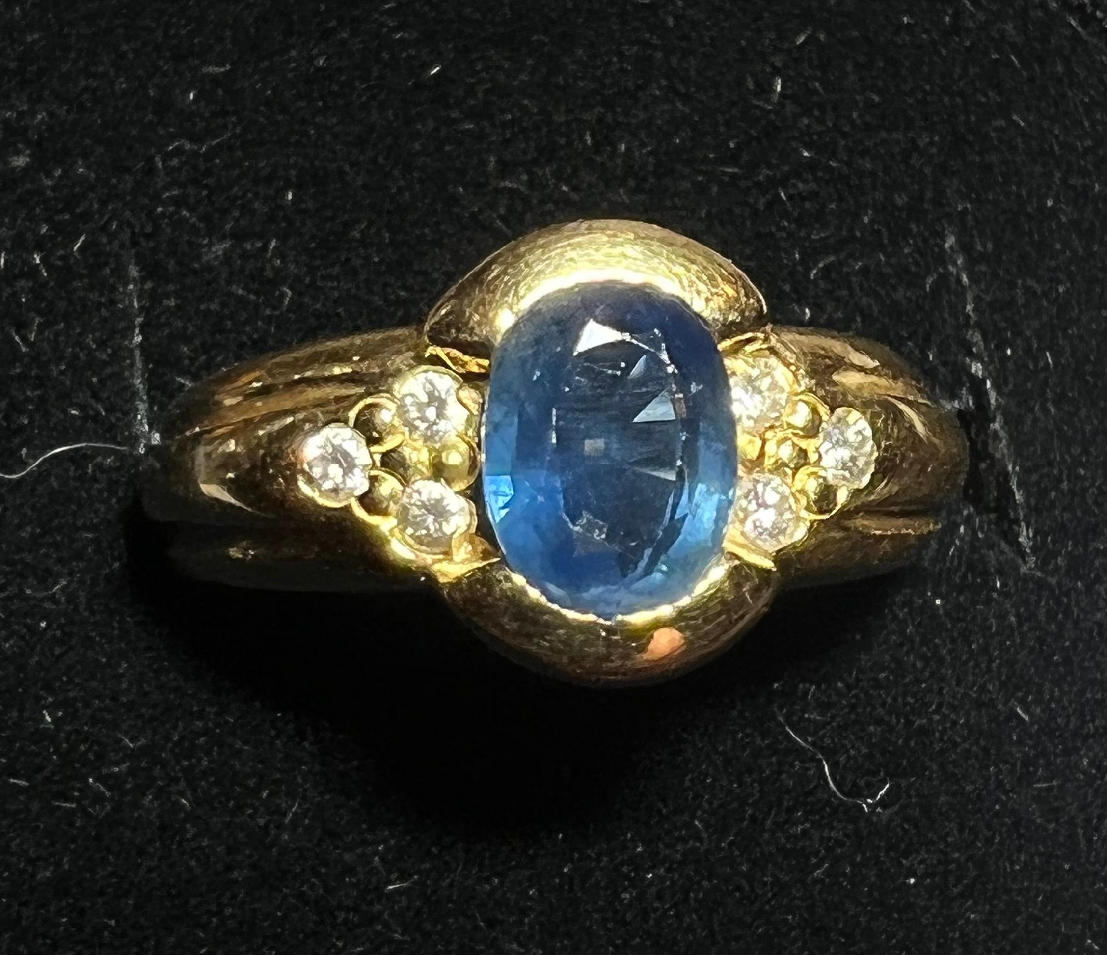 Engagement Ring in 18 Carat Gold Set with a Sapphire Surrounded by Diamonds 3