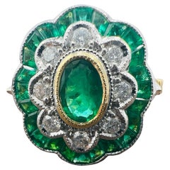Engagement ring in 18 carat gold set with emeralds and pavé diamonds