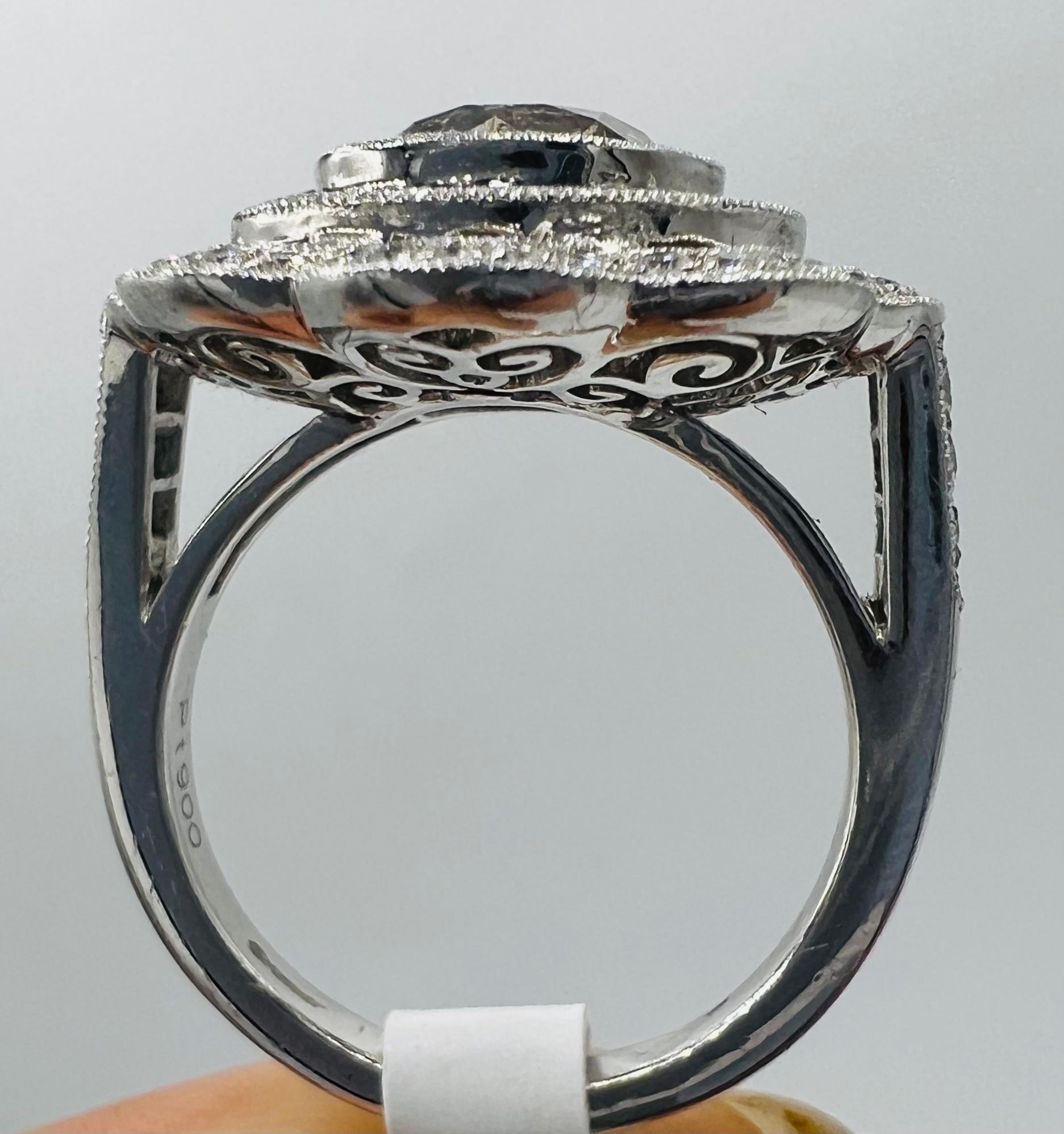 Women's engagement ring in platinum, solitaire surrounded by sapphires and diamonds