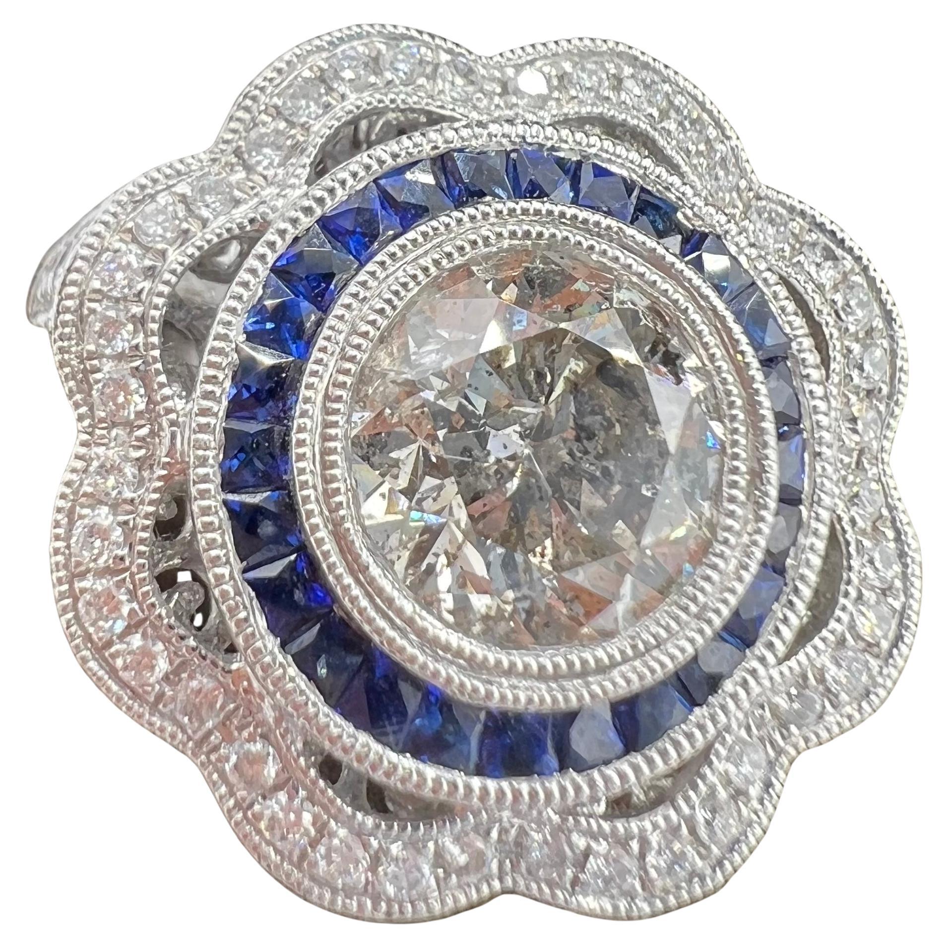 engagement ring in platinum, solitaire surrounded by sapphires and diamonds