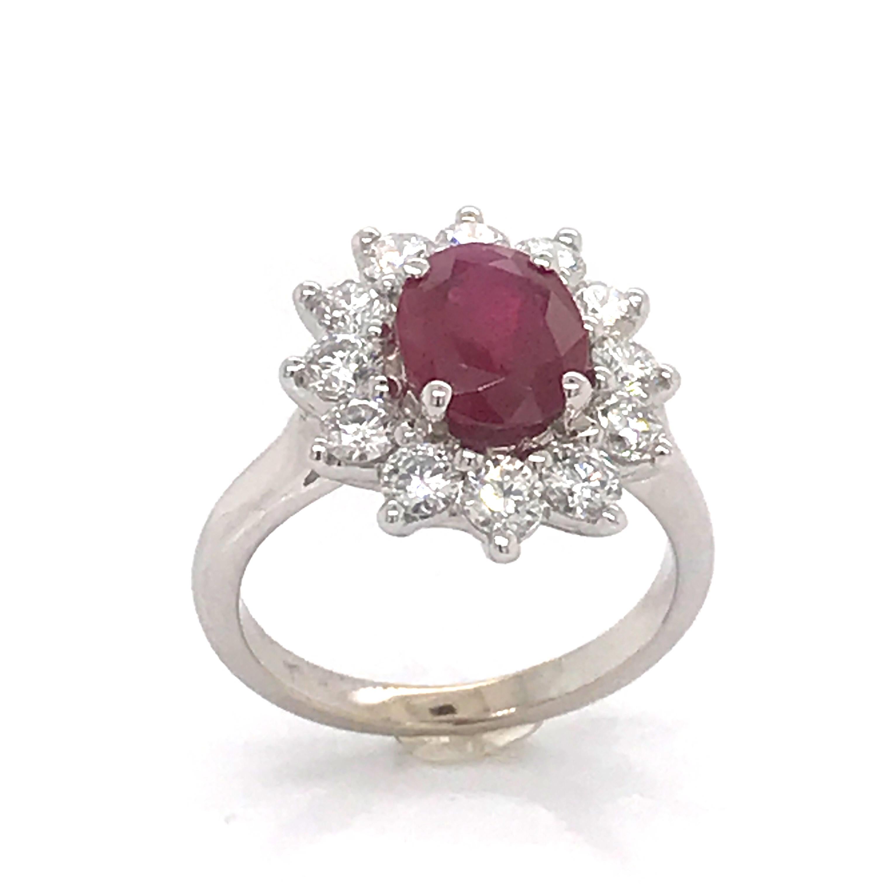 Introduce a touch of timeless beauty and dazzling sparkle to your marriage proposal with this magnificent 18-carat white gold engagement ring. Showcasing a 2.06 carat oval ruby, carefully selected for its vibrant colour and crystal clarity, this