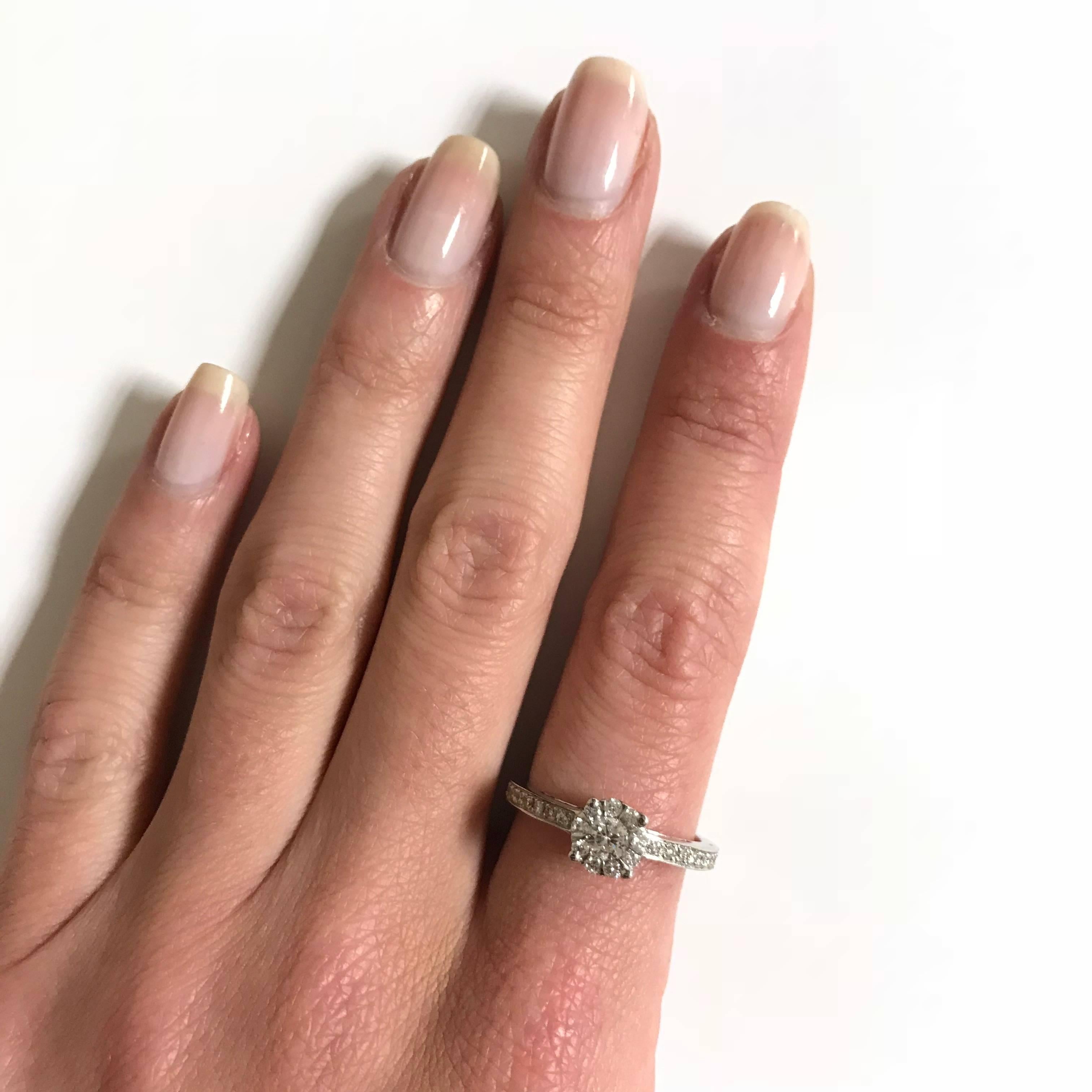 This exquisite ring is crafted with a total of 49 dazzlingly brilliant White Diamonds, totaling 0.49 carats. Each diamond is carefully chosen for its dazzling purity and perfect cut, giving it an enchanting glow that will illuminate your hand with