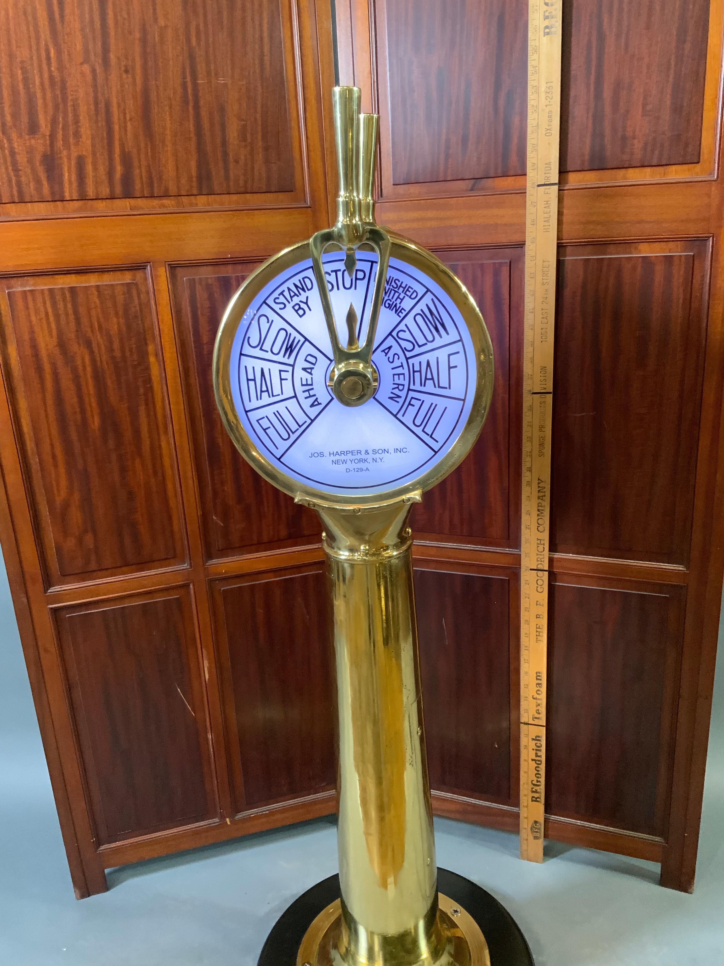 This is a meticulously polished and lacquered telegraph that has its bells ringing, is wired with lighting, and is mounted to a thick wood base. Circa 1940. Dimensions: H: 47