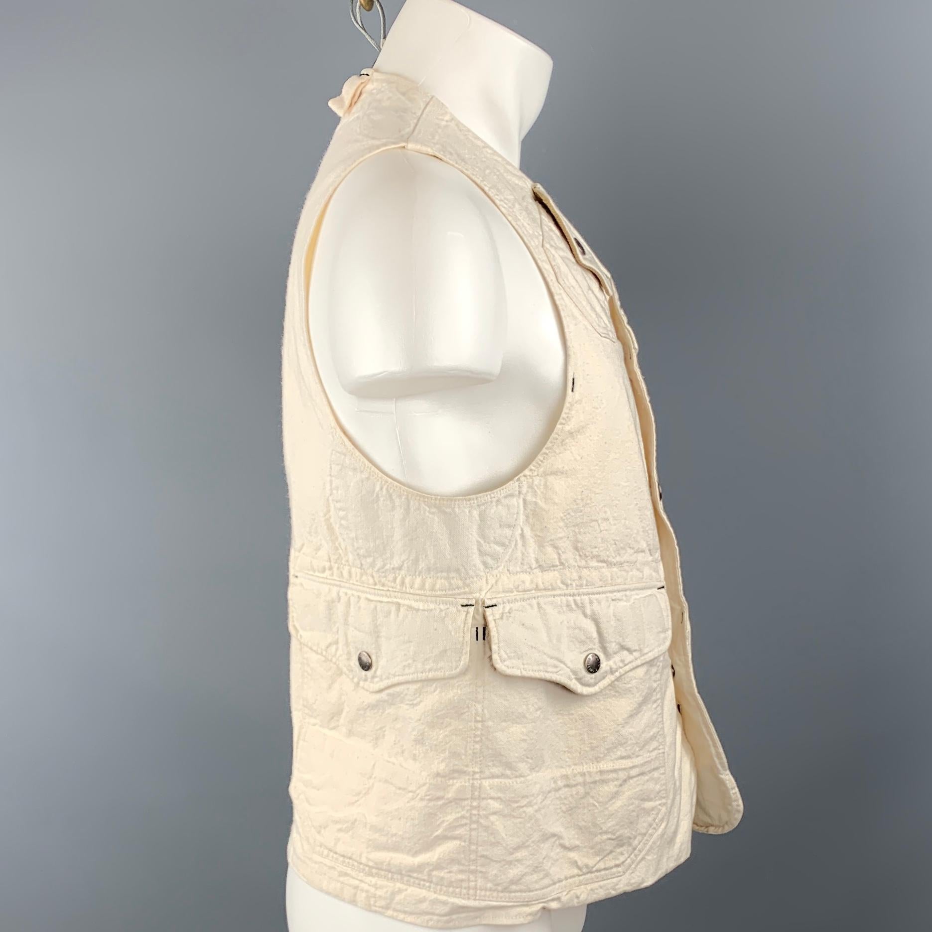 ENGINEERED GARMENTS vest comes in a off white cotton featuring patch pocket details, inner corduroy panels, and a buttoned closure. Minor discoloration. As Is. Made in USA.
 

Very Good Pre-Owned Condition.
Marked: M

Measurements:

Shoulder: 13 in.