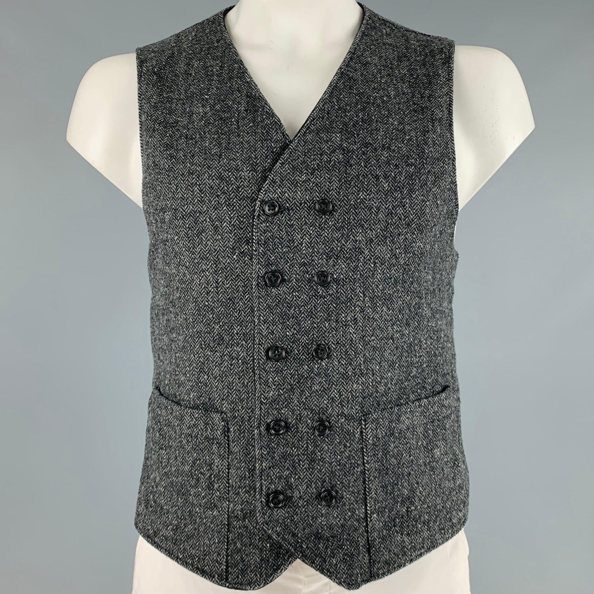 ENGINEERED GARMENTS vest
in a grey wool blend fabric featuring a reversible style with a herringbone pattern on one side and stripe pattern on the other, and double breasted button closure.Excellent Pre-Owned Condition. 

Marked:   L 

Measurements: