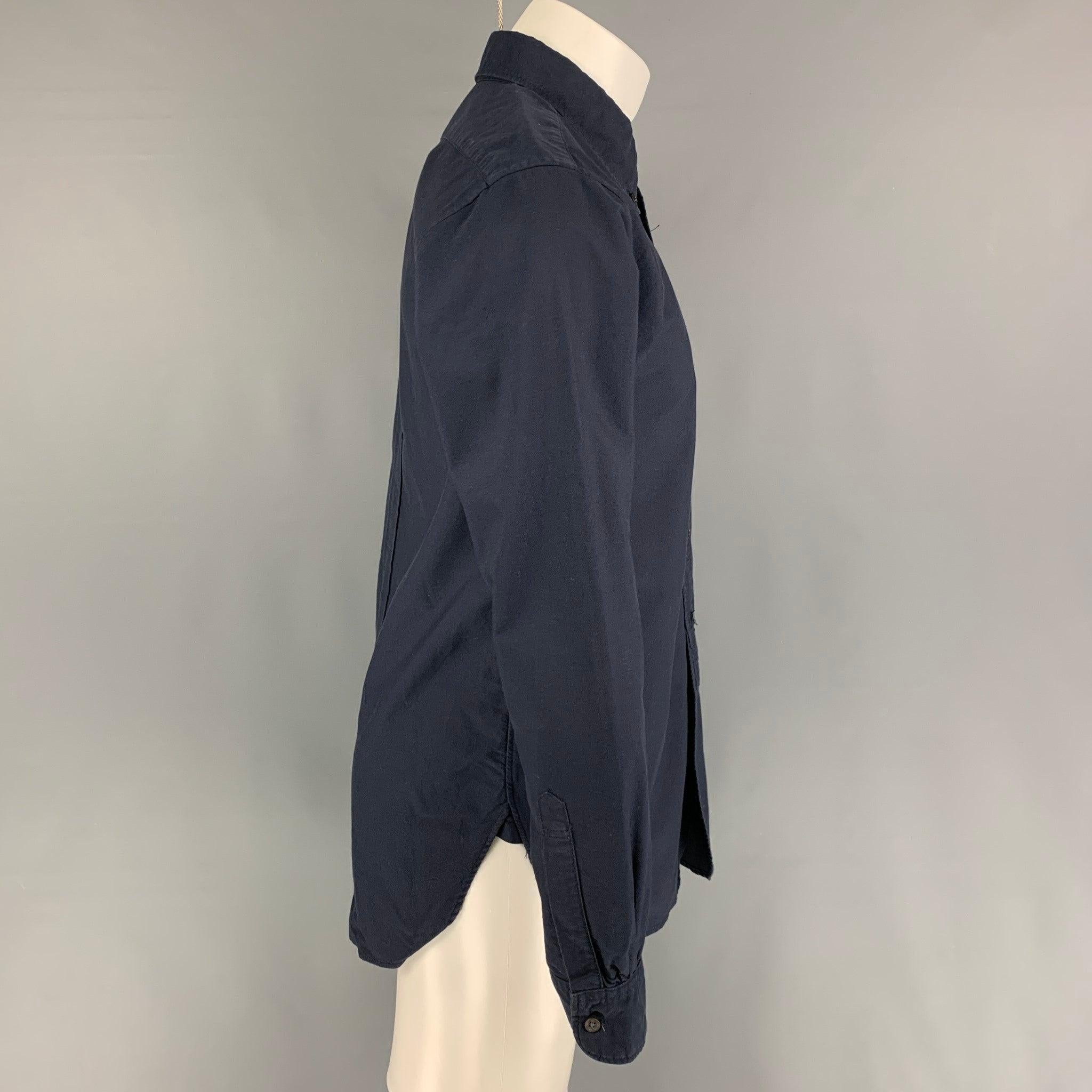ENGINEERED GARMENTS long sleeve shirt comes in a navy cotton featuring a button down collar, patch pocket, and a button up closure. Made in USA. Very Good
Pre-Owned Condition. 

Marked:   M  

Measurements: 
 
Shoulder: 18 inches  Chest: 40 inches 