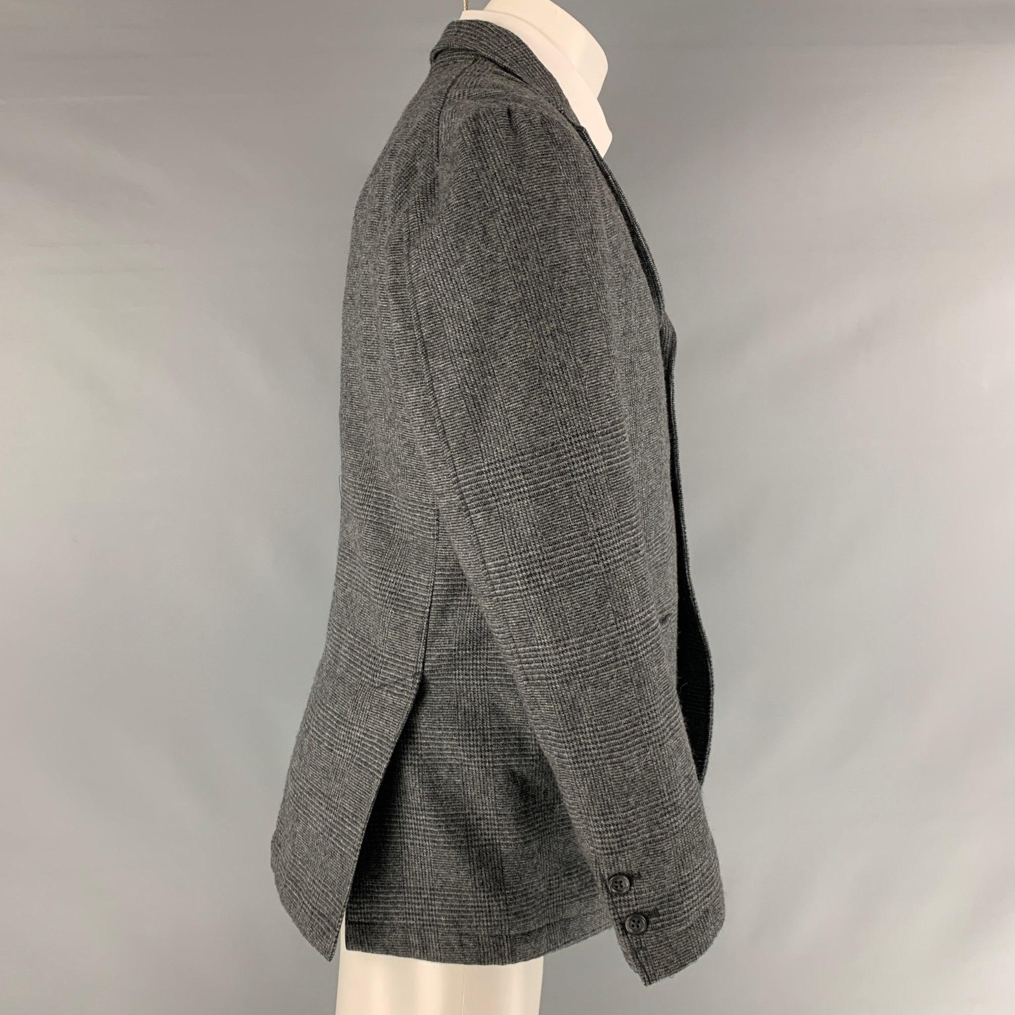 ENGINEERED GARMENTS sport coat comes in a black and grey glenplaid wool woven material featuring a notch lapel, flap pockets, double back vent, and a double button closure. Made in USA.Excellent Pre- Owned Material. 

Marked:   S 

Measurements: 
