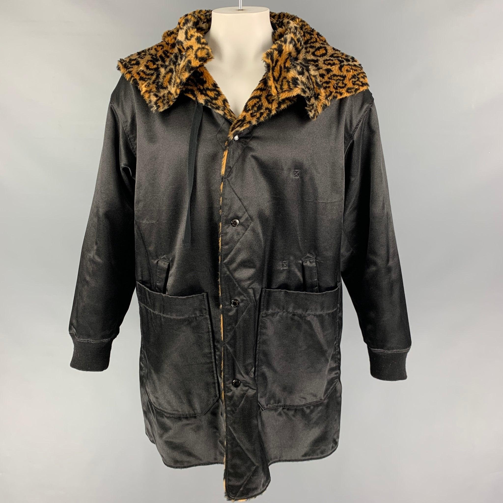 ENGINEERED GARMENTS coat comes in a black & tan animal print polyester / cotton featuring a reversible style, hooded, cut-out details, drawstring, slit pockets, and a snap button closure. Made in USA.
Very Good
Pre-Owned Condition. 

Marked:   L 