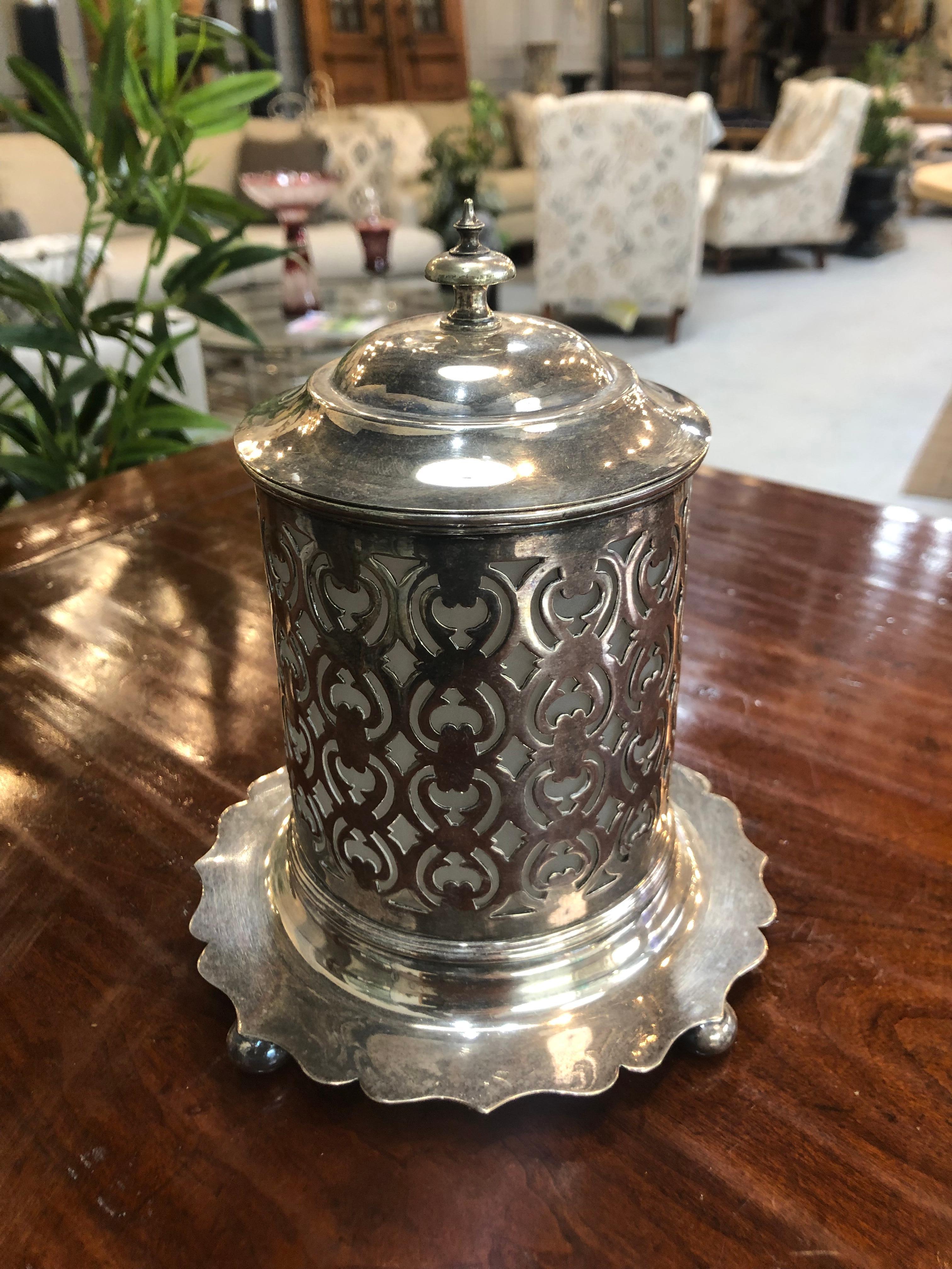 Late 19 century pierced silver plated jam pot with a frosted liner and bun feet circa 1880 England. This is a wonderful piece from a private collector but I do not believe the frosted liner is original to the piece but it does fit well.