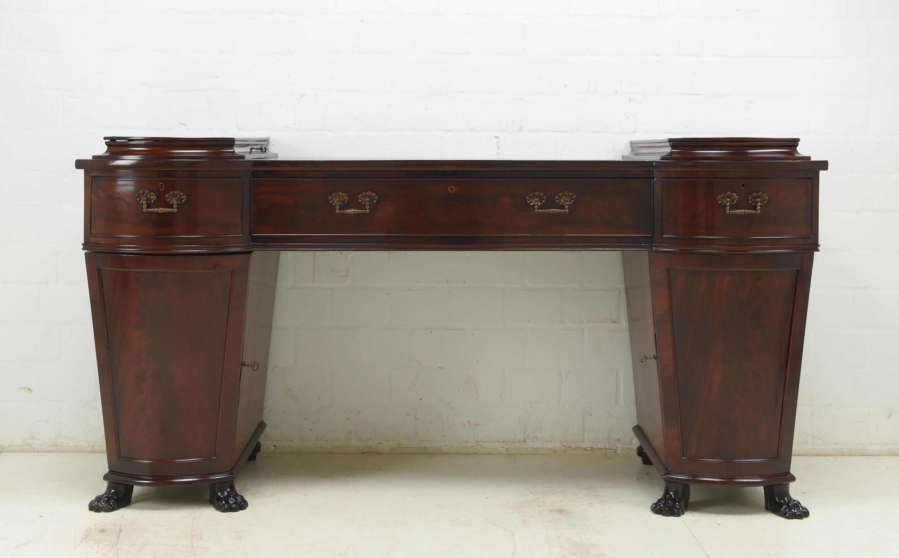Pedestal sideboard restored England circa 1800 mahogany console

Features:
Two-door model with drawers, folding compartment, secret drawer and side secret door
Very high quality processing
Drawers pronged
Original fittings and locks
Original