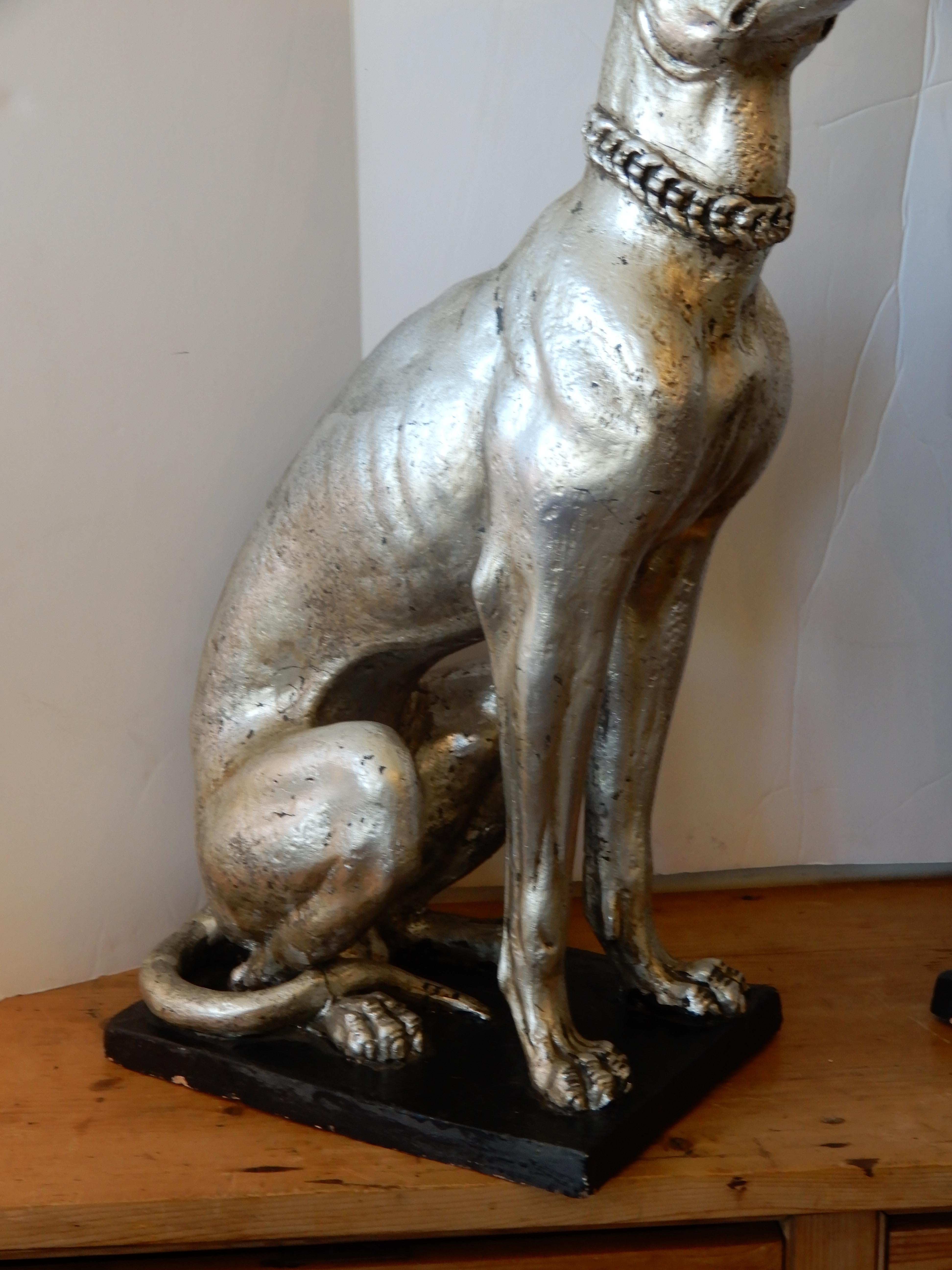 A wonderful pair of Art Deco whippet dogs from England which formally sat left and right of a large fireplace, look good on the floor or up high, both sitting on a black metal stand and looking rather proud.
The stand measures 14 x 10.
The dogs