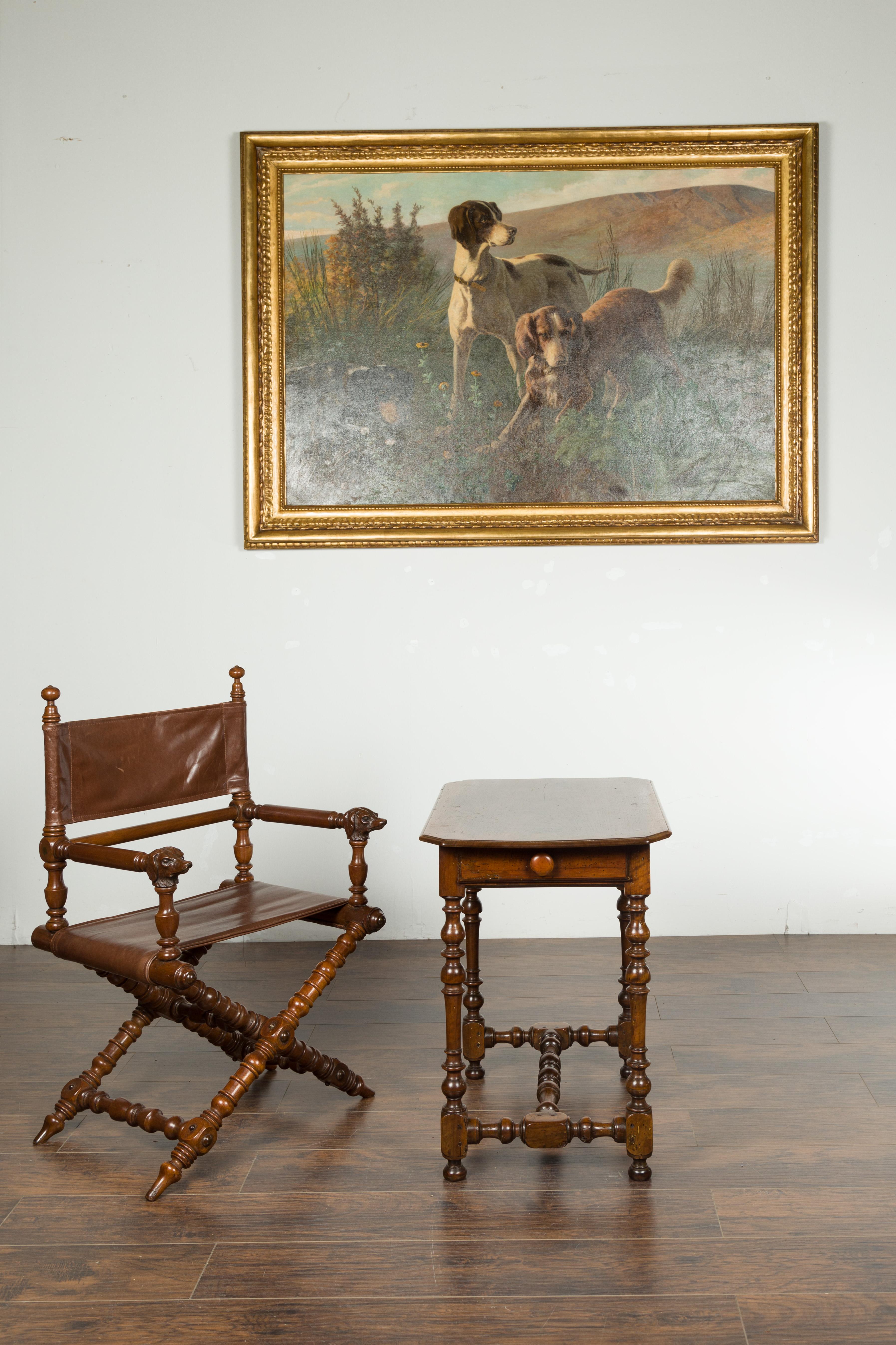 An English George III walnut side table from the early 19th century, with single drawer and turned legs. Created in England during the first quarter of the 19th century, this walnut side table features a rectangular top sitting above an apron