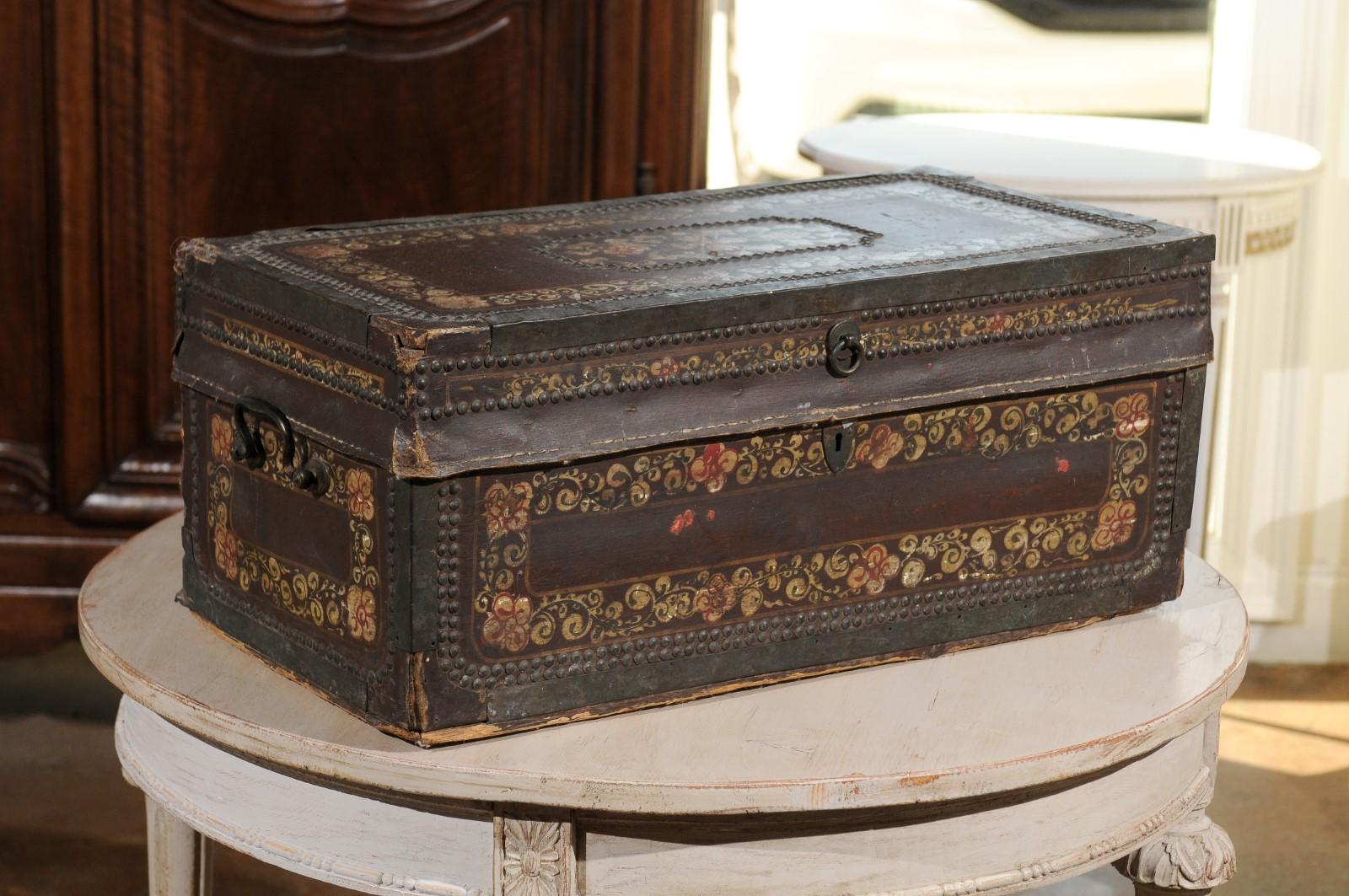 An English painted Regency period camphor wood trunk from the early 19th century, with hand painted floral decor. Born in England during the Regency period, this exquisite camphor wood and leather trunk features a lovely painted décor of petite