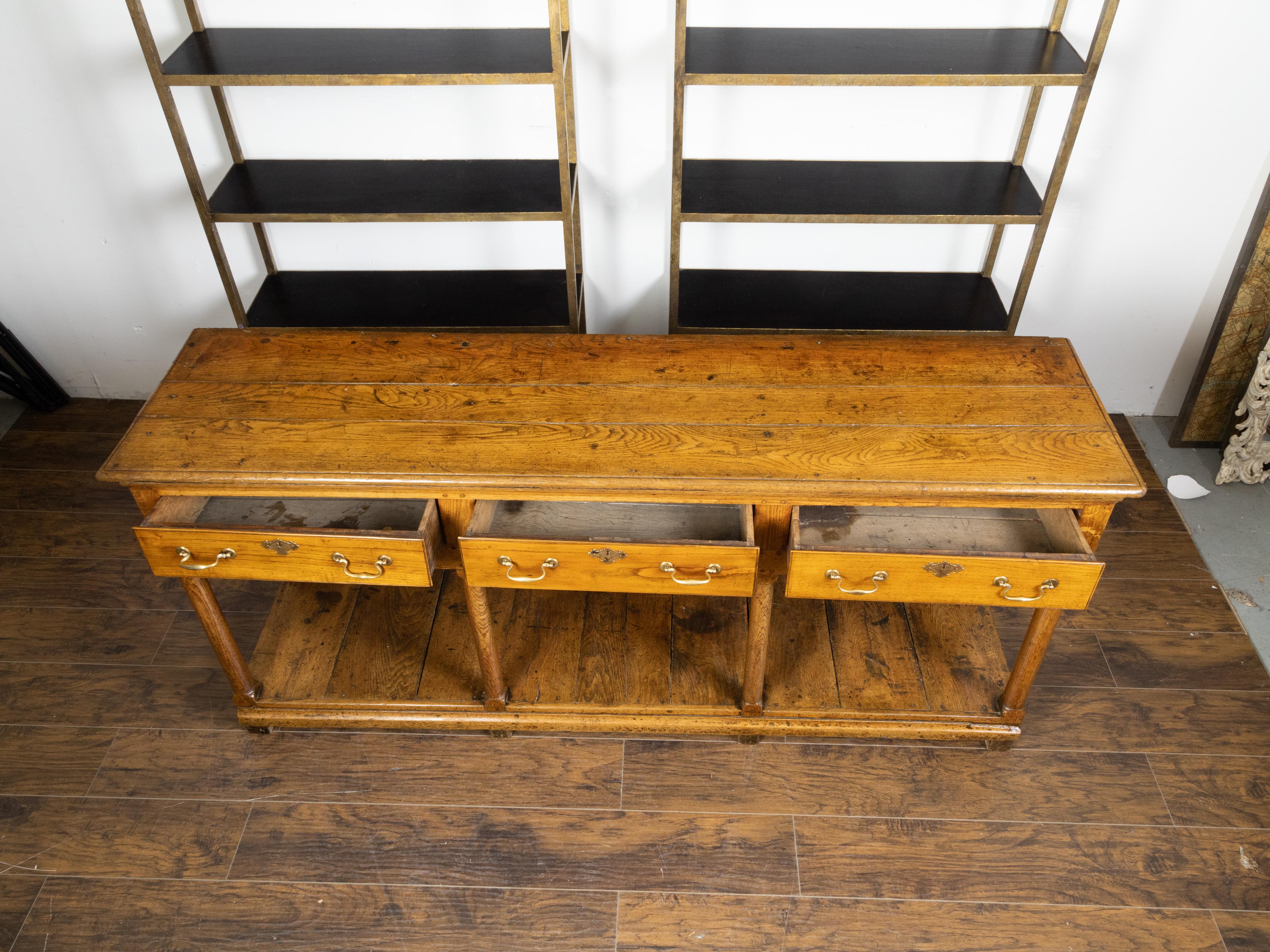 Brass English 1820s Georgian Dresser Base with Three Drawers and Pot Board Shelf