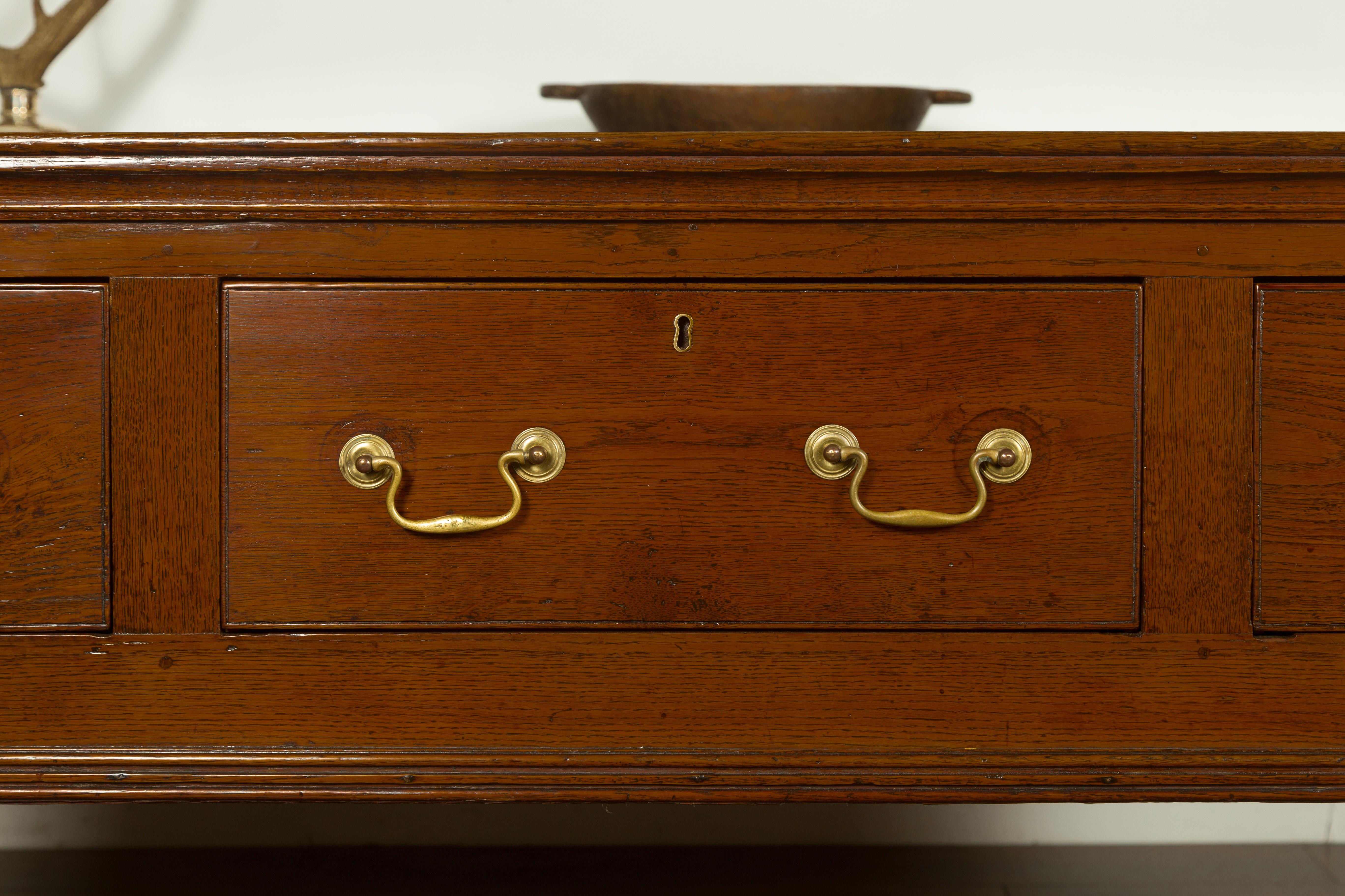 19th Century English 1820s Georgian Period Oak Dresser Base with Three Drawers and Pad Feet