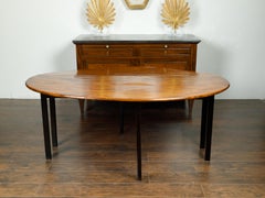 English 1820s Mahogany Drop Leaf Dining Table with Oval Top and Ebonized Legs