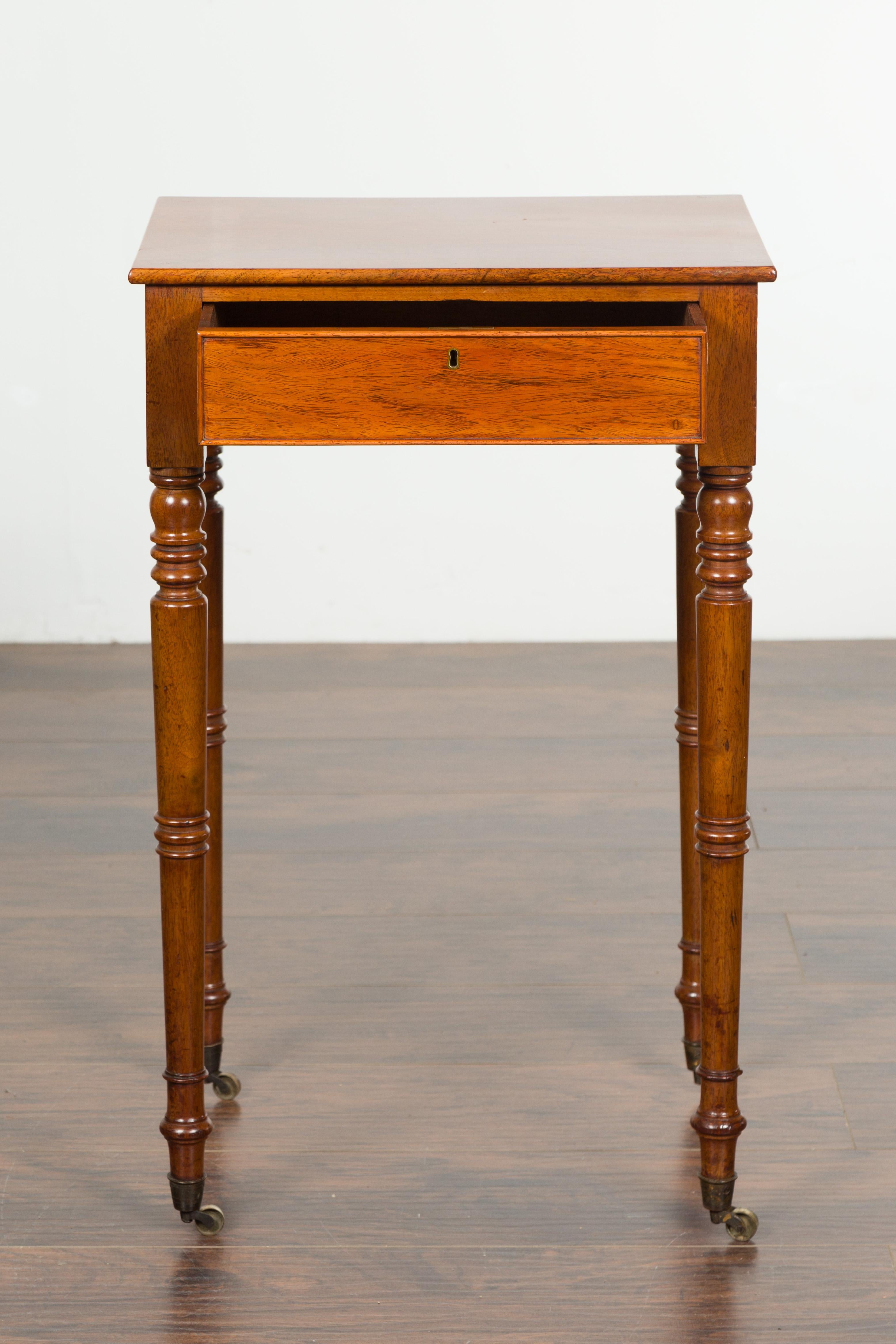 English 1820s Walnut Side Table with Single Drawer, Turned Legs and Casters For Sale 4