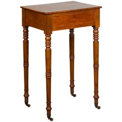 English 1820s Walnut Side Table with Single Drawer, Turned Legs and Casters