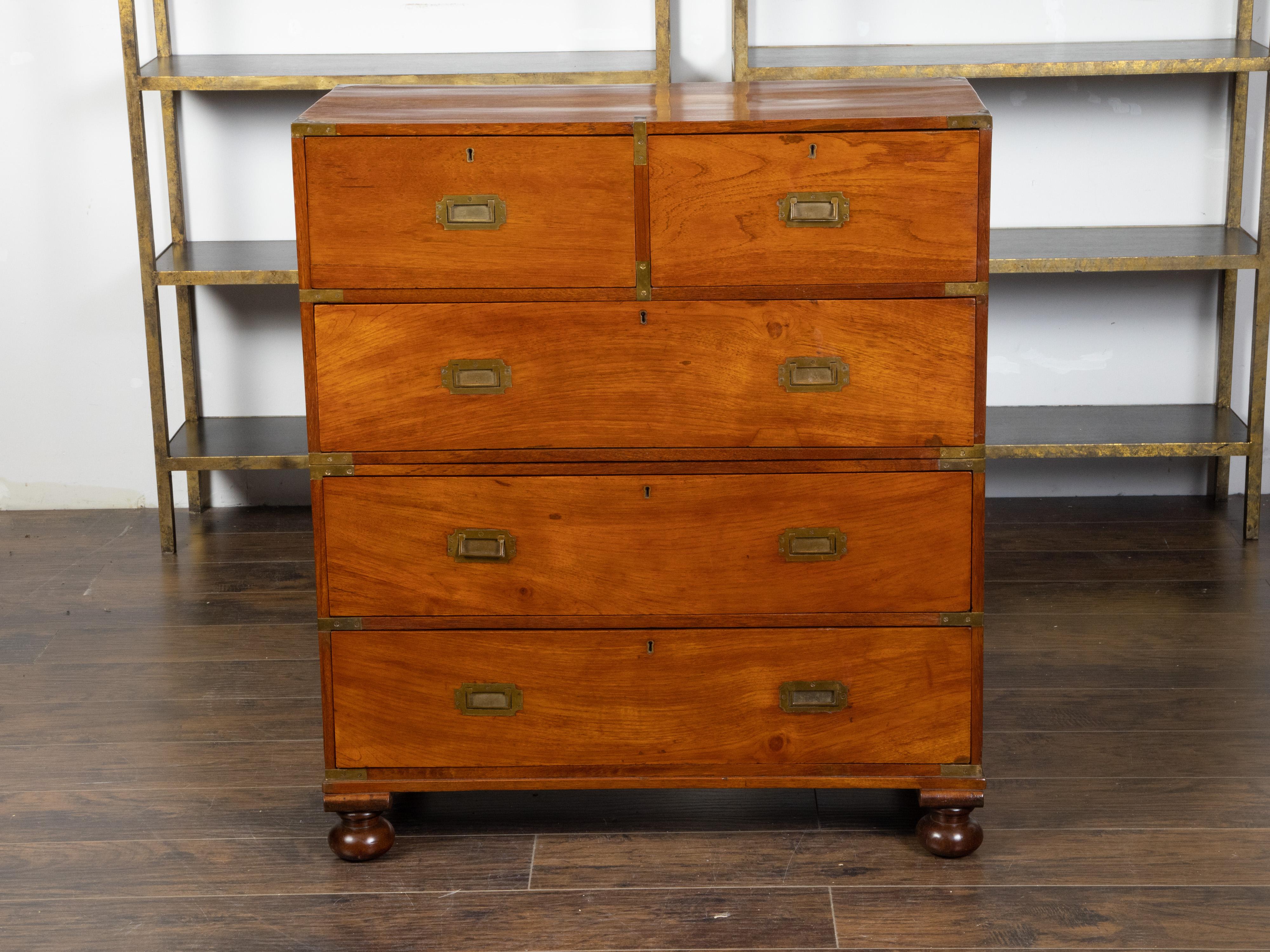 An English mahogany campaign chest from the mid 19th century, with five drawers and brass hardware. Created in England during the second quarter of the 19th century, this mahogany campaign chest is made of two parts flanked with lateral handles to