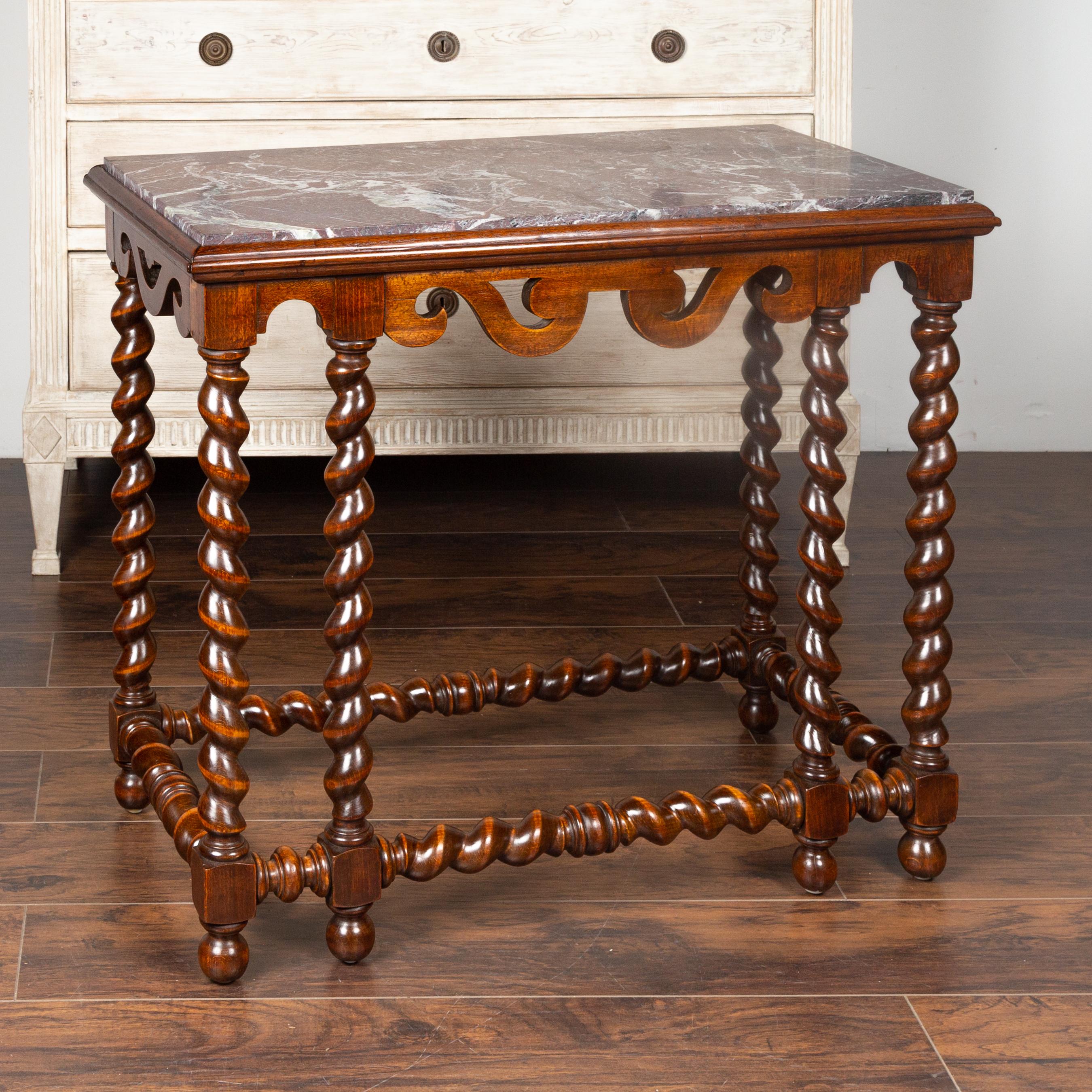 An English barley twist mahogany console table from the mid-19th century, with red marble top. Born in England during the mid-19th century, this exquisite console table features a rectangular red veined marble top inset sitting above an apron carved