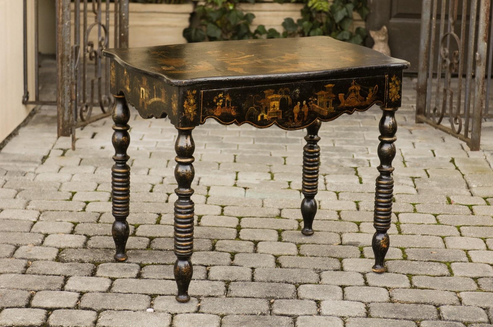 An English chinoiserie table from the mid-19th century, with ebonized wood and hand painted décor. Born in England during the 1850s, this side table features a rectangular, serpentine top adorned with an exquisite hand painted chinoiserie scene.