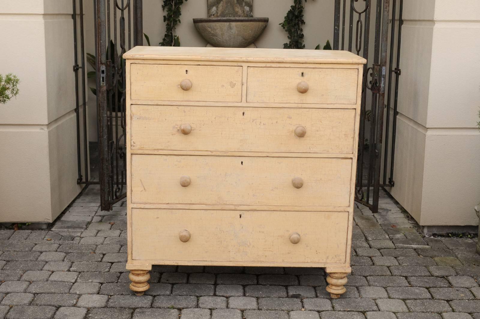 An English Georgian style five-drawer commode from the mid-19th century, dry-scrubbed to its original paint. This tall English chest features a rectangular top sitting above five dovetailed drawer. The upper section comprises two small drawers,
