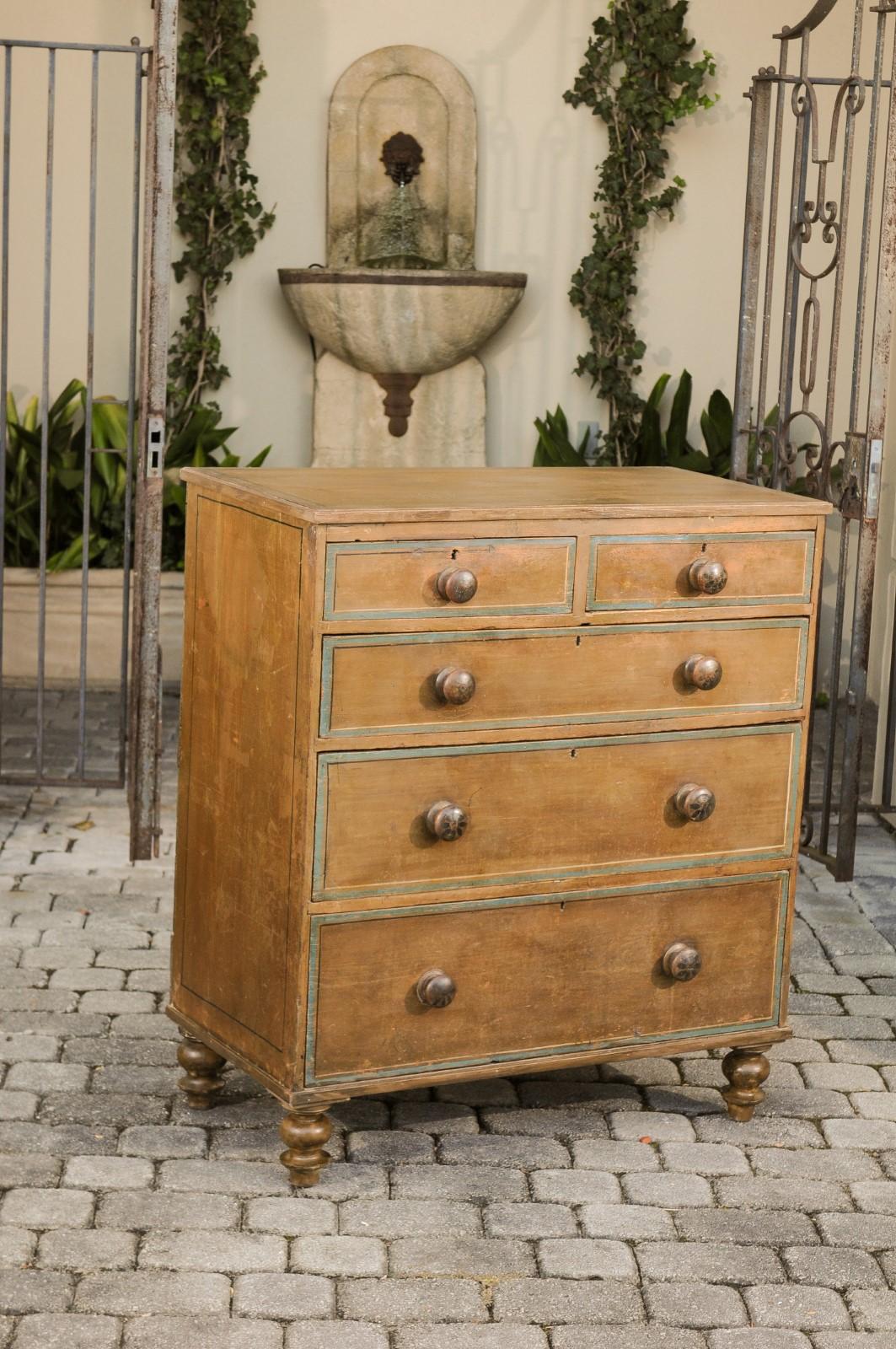 An English painted wood chest from the mid-19th century with graduated drawers and turned feet. Born in England during the mid-19th century, this chest-of-drawers charms us with its simple elegance and nicely worn patina. Featuring a rectangular top