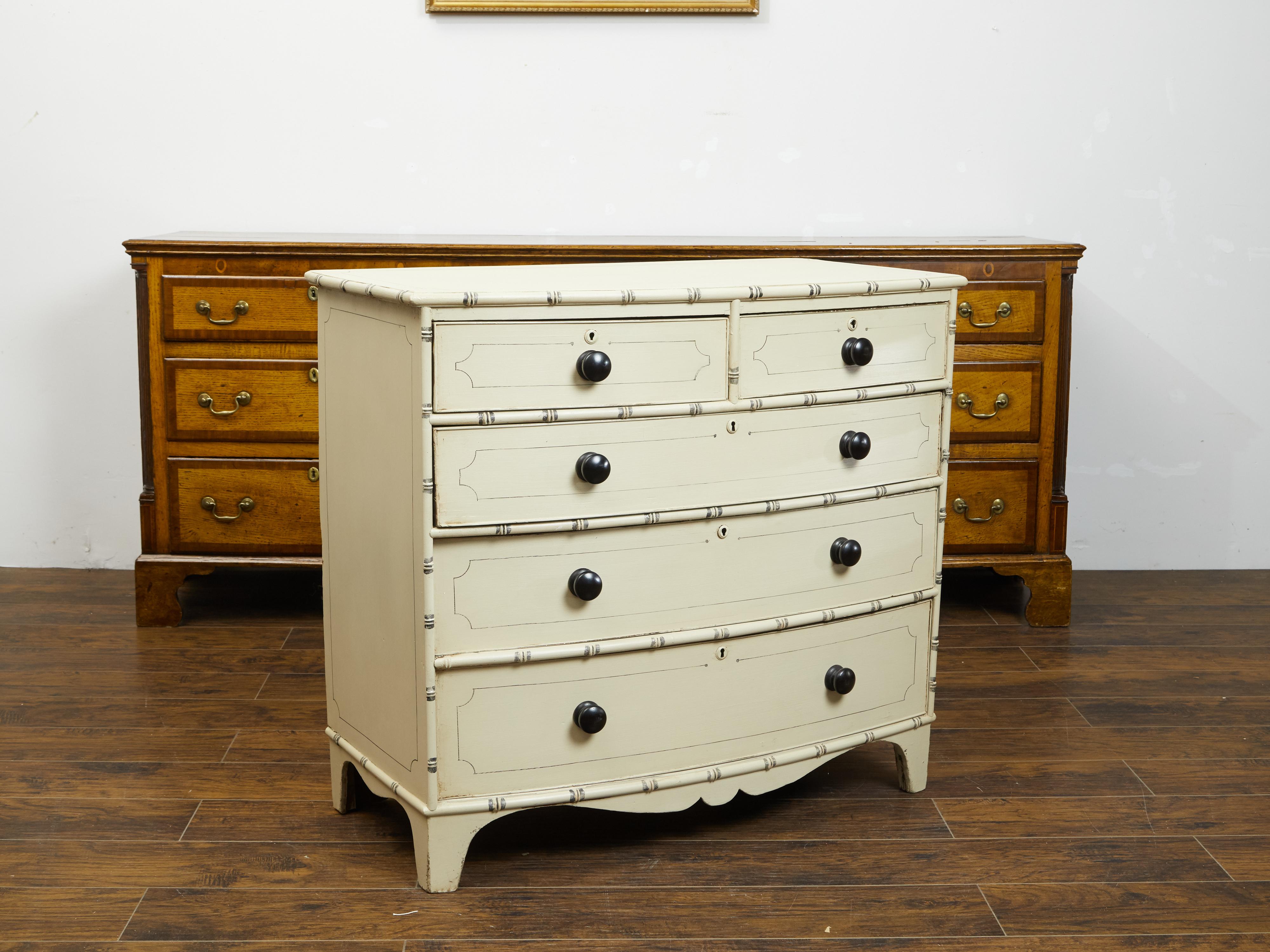 An English bow front five-drawer chest from the mid 19th century, with new paint. Created in England during the third quarter of the 19th century, this painted chest features a rectangular bow front top sitting above five drawers (two small ones