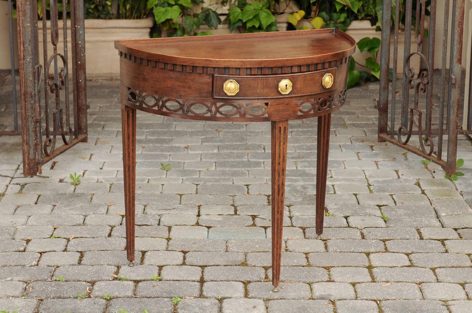 Carved English 1860s Oak Demilune Table with Drawer, Tapered Legs and Pierced Motifs For Sale