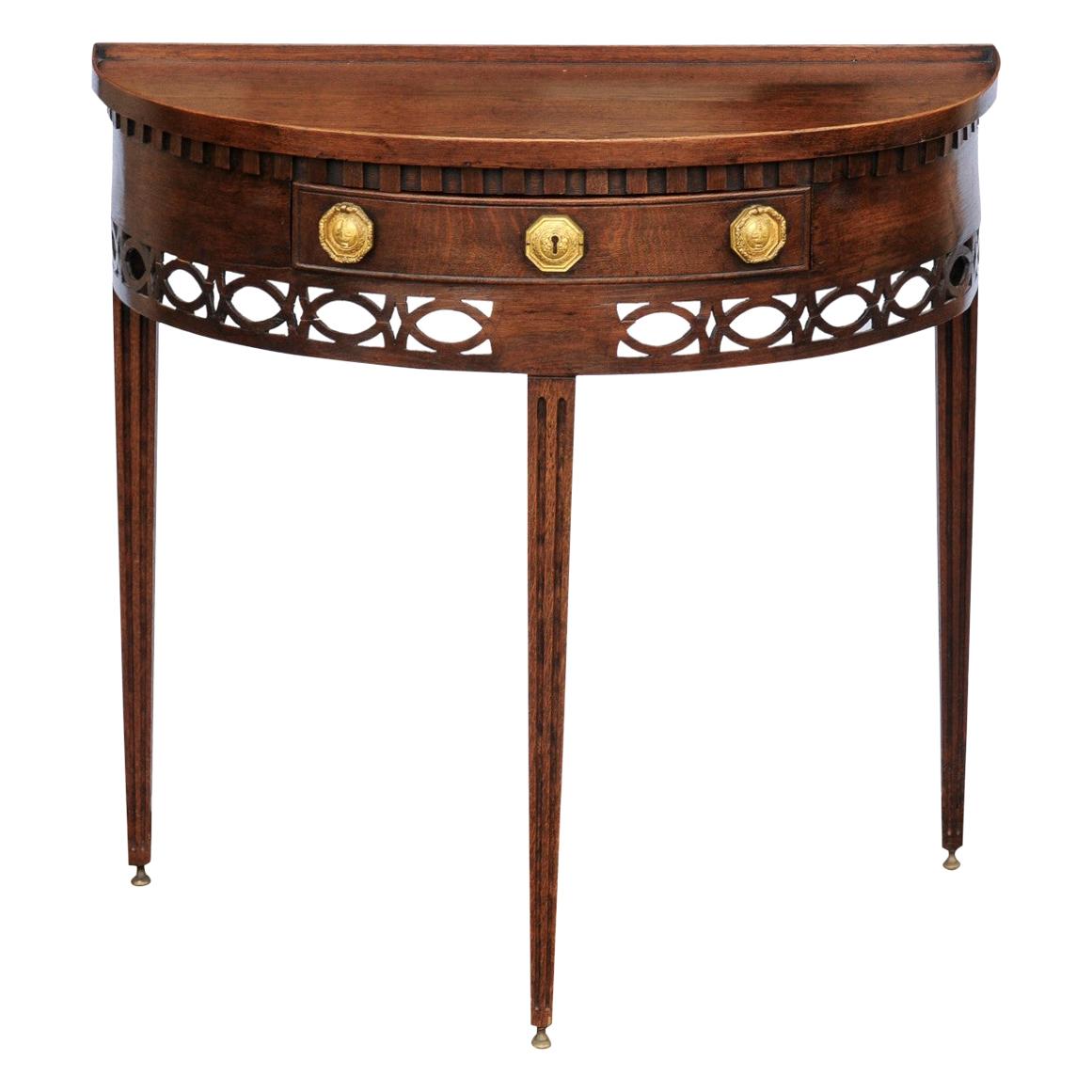 English 1860s Oak Demilune Table with Drawer, Tapered Legs and Pierced Motifs For Sale