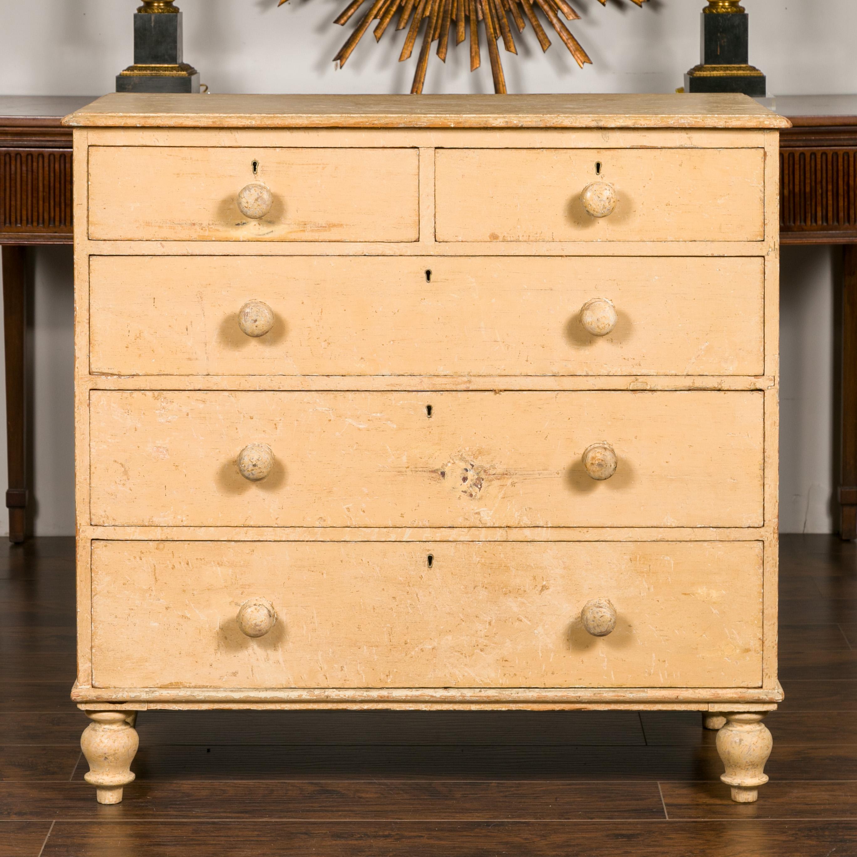 An English painted wood chest from the mid-19th century, with five graduating drawers, turnip feet and distressed finish. Born in England during the third quarter of the 19th century, this painted chest features a rectangular top sitting above five