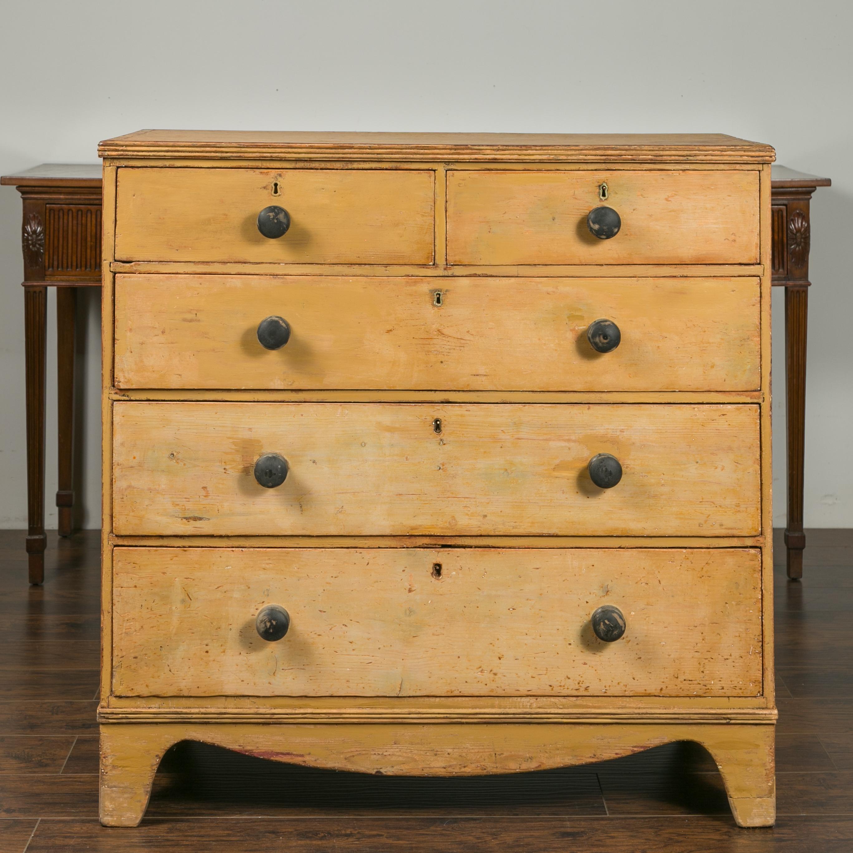 An English pine chest from the mid-19th century, with five drawers and valanced apron. Born in England during the third quarter of the 19th century, this pine chest features a rectangular top with nicely worn appearance and reeded edges, sitting