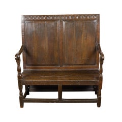 Antique English 1870s Oak Bench with Carved Frieze, Scrolling Arms and Turned Legs