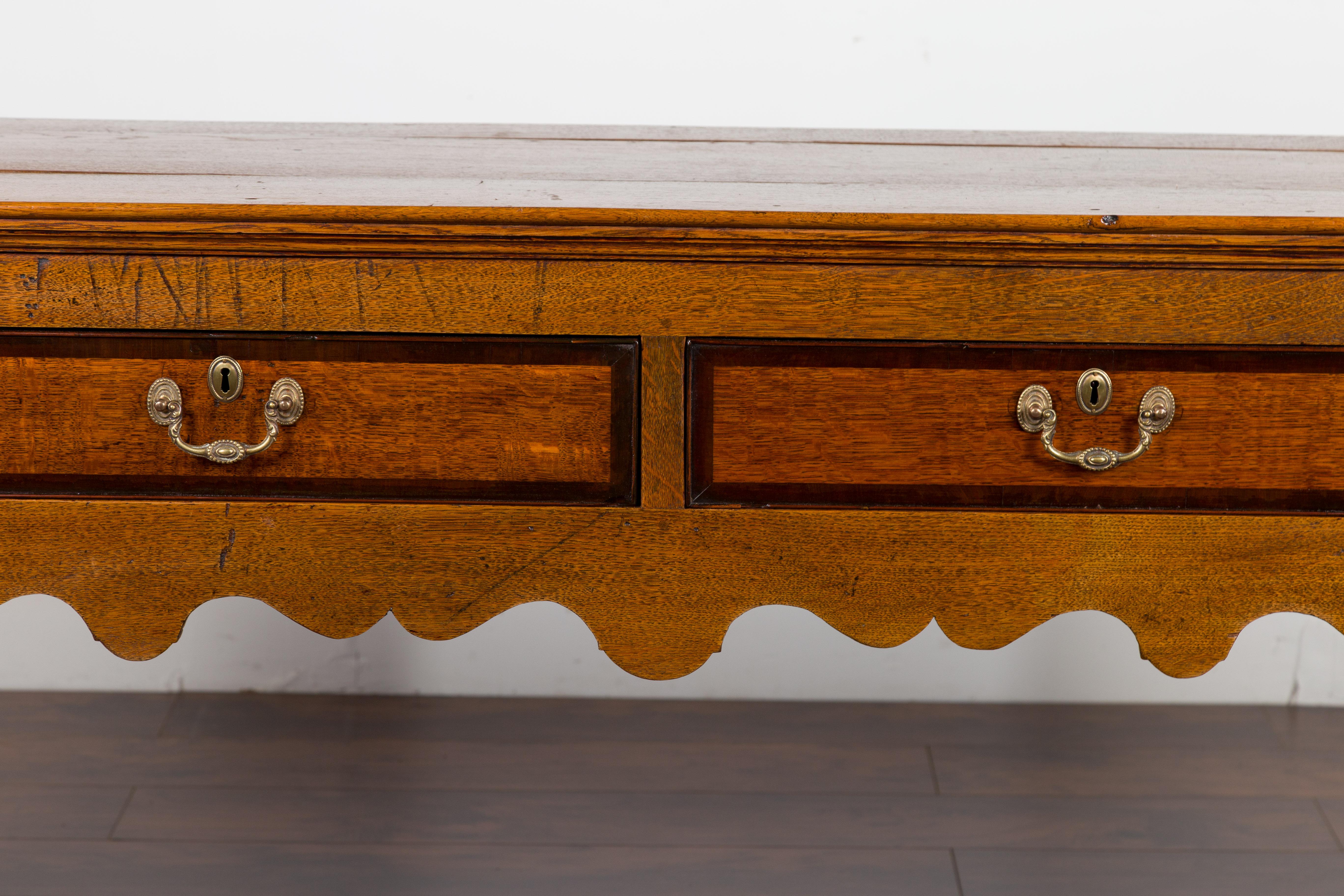 English 1870s Oak Dresser Base with Two-Toned Drawers and Scalloped Apron 3