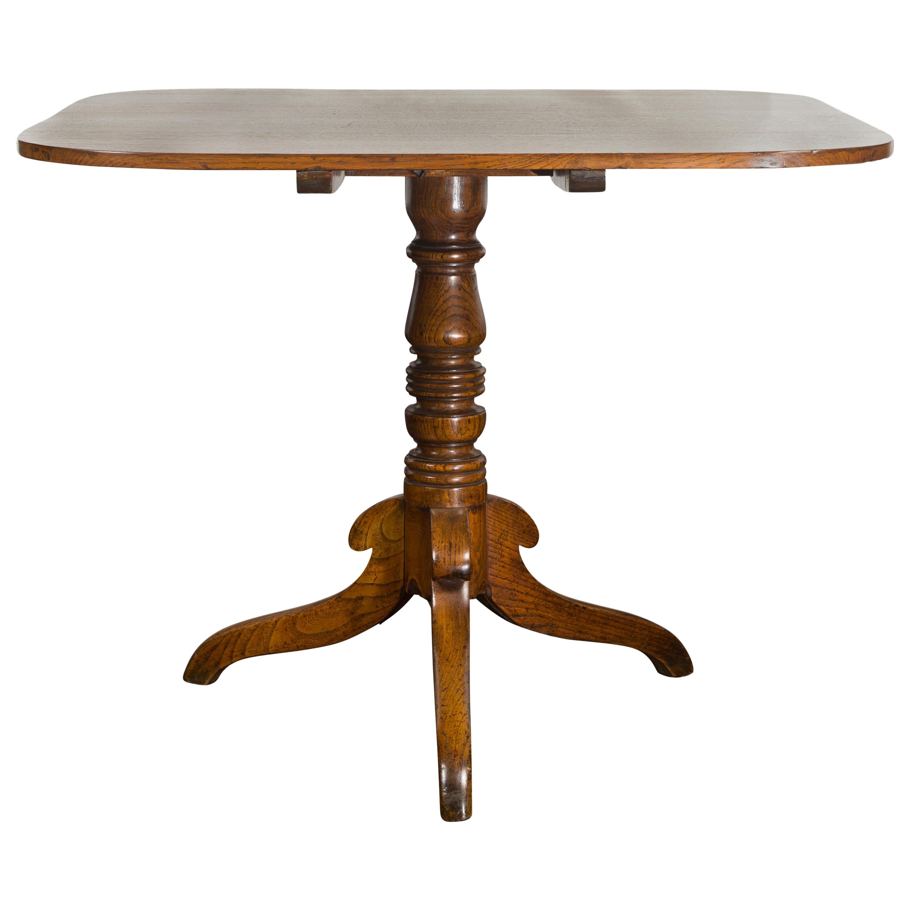 English 1870s Oak Tilt-Top Table with Turned Pedestal and Tripod Scrolling Feet For Sale