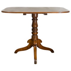 English 1870s Oak Tilt-Top Table with Turned Pedestal and Tripod Scrolling Feet