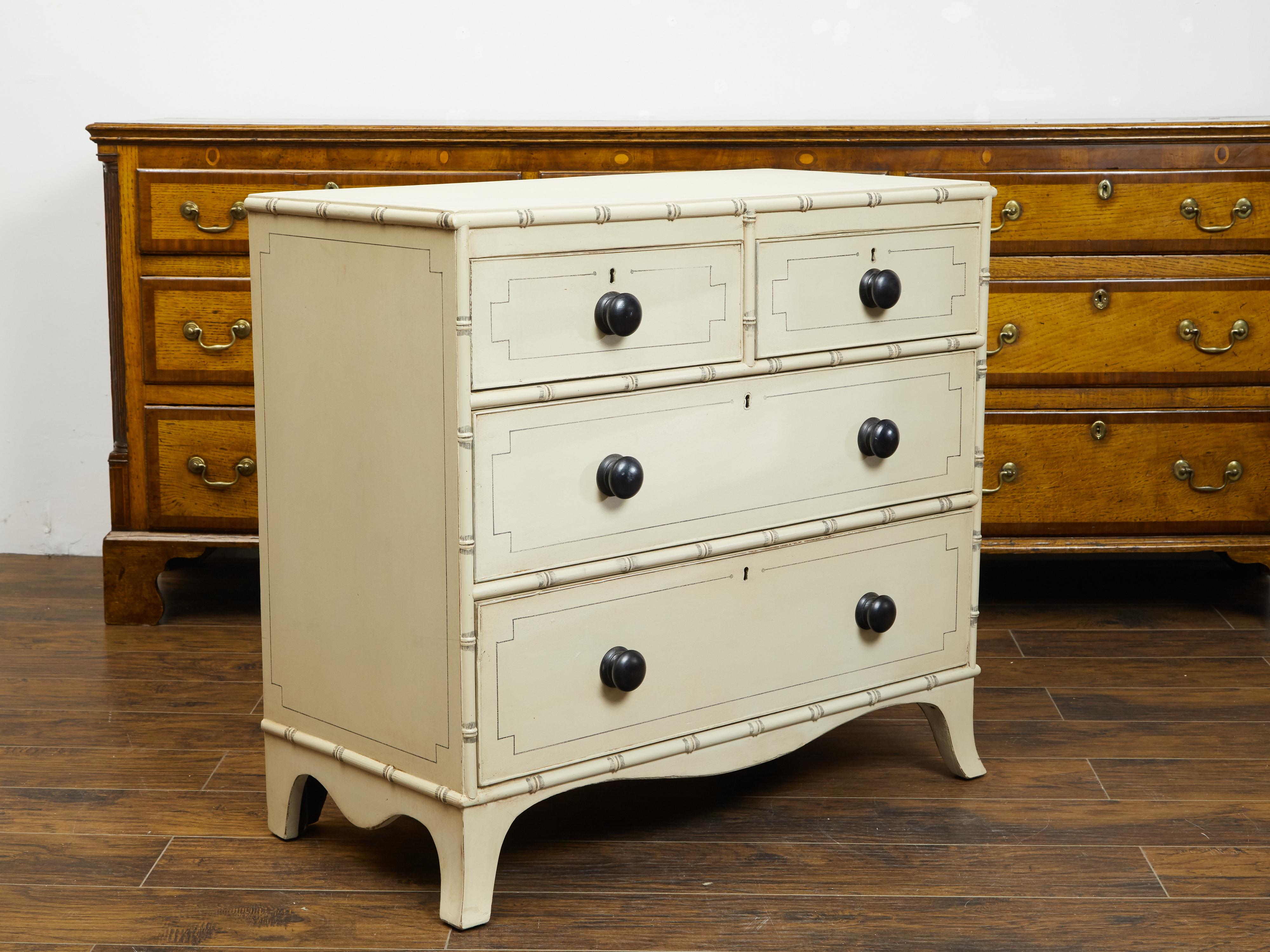 An English painted wood four-drawer chest from the late 19th century, with new paint. Created in England during the third quarter of the 19th century, this chest features a rectangular top with painted outline, sitting above four drawers (two small