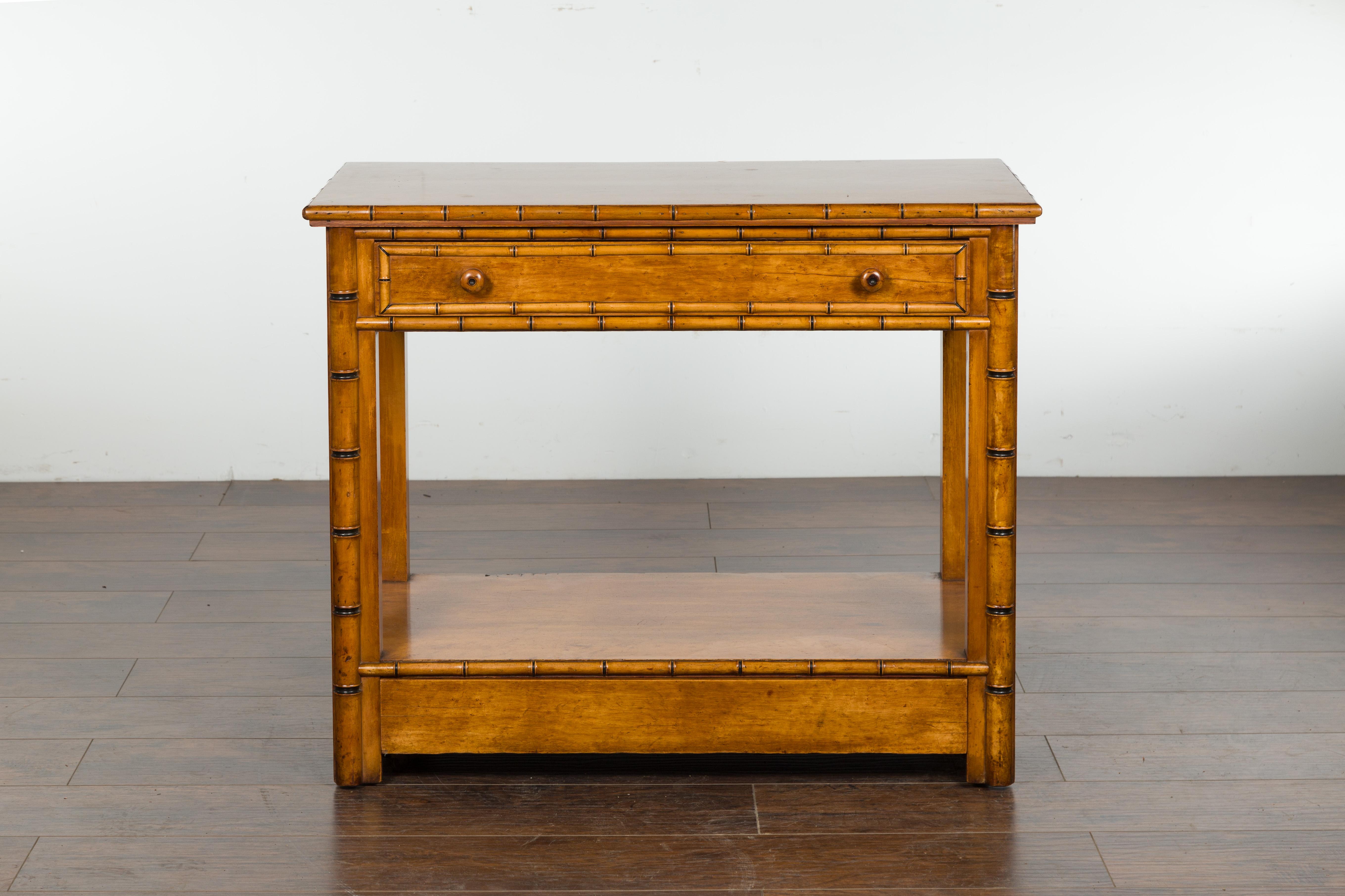 An English burl walnut faux bamboo table from the late 19th century, with ebonized accents, single drawer, lower shelf and petite hidden wheels. Created in England during the last quarter of the 19th century, this faux bamboo table features a