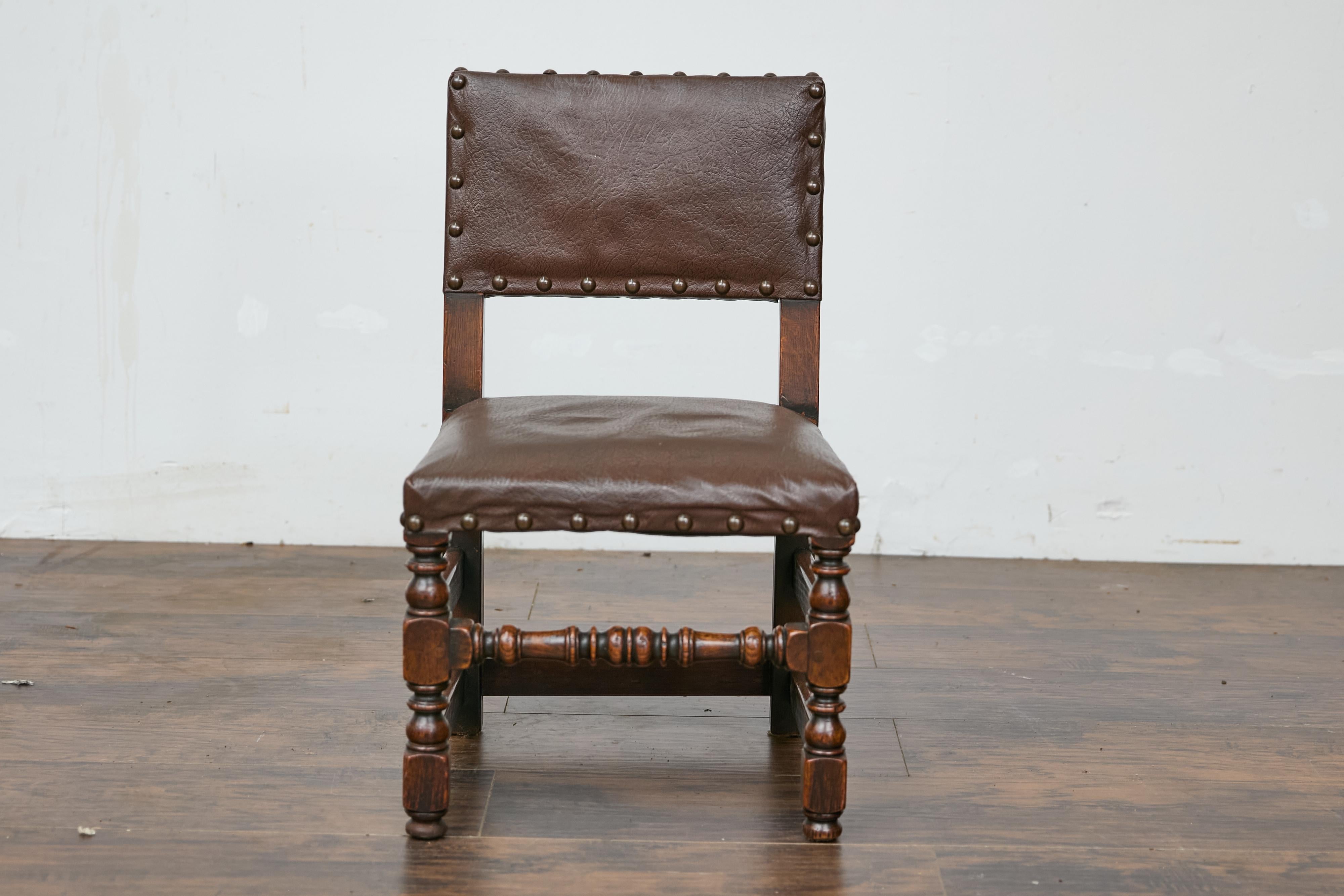 An English child's chair from circa 1880 with turned legs and oilcloth upholstery. This charming English child's chair from circa 1880 brings a delightful touch of history and craftsmanship to any home. Featuring turned front legs and straight hind