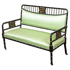 English 1880s Ebonised Faux Bamboo Bench with Gilt Accents and Green Upholstery