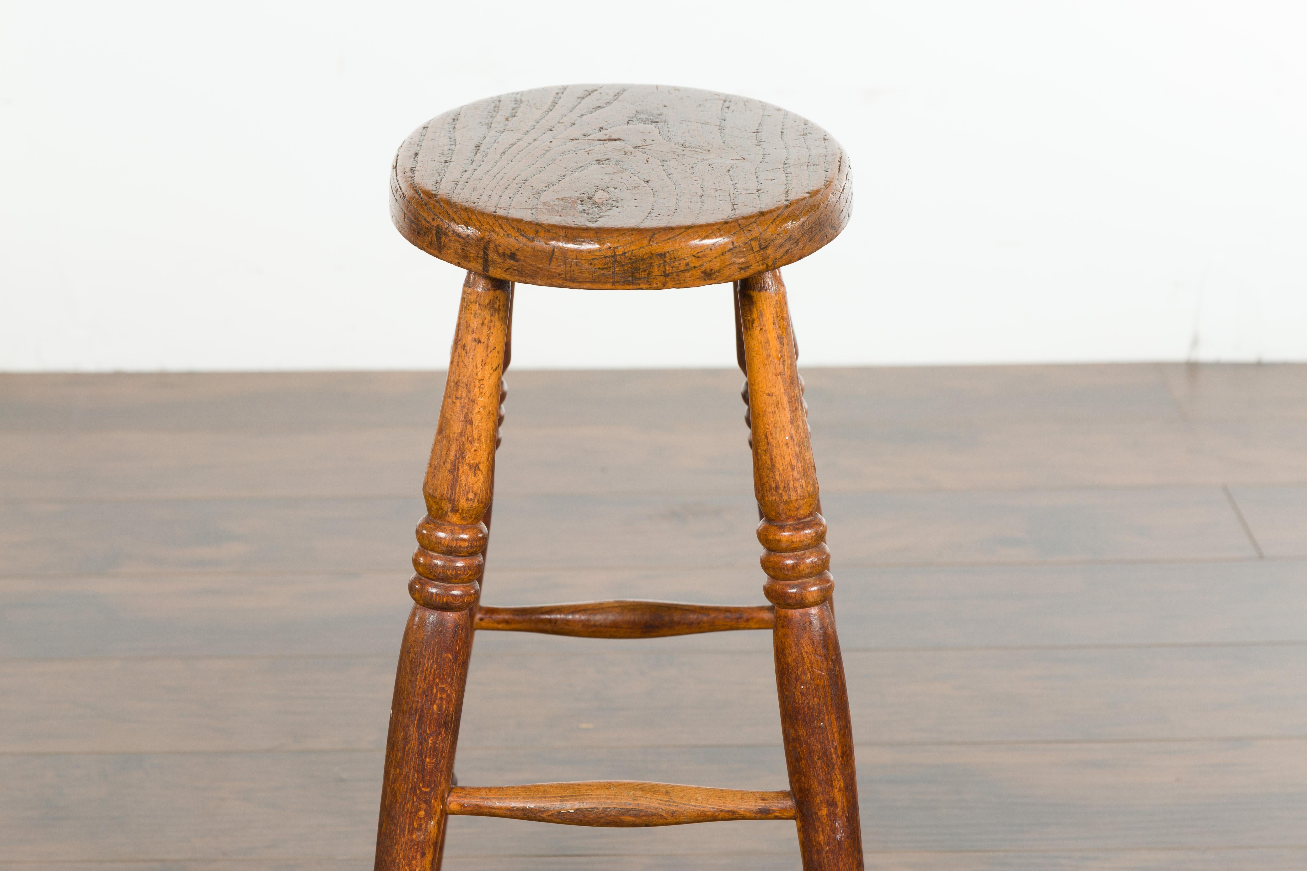 English 1880s Elm Stool with Oval Seat, Turned Splaying Legs and Side Stretchers 4