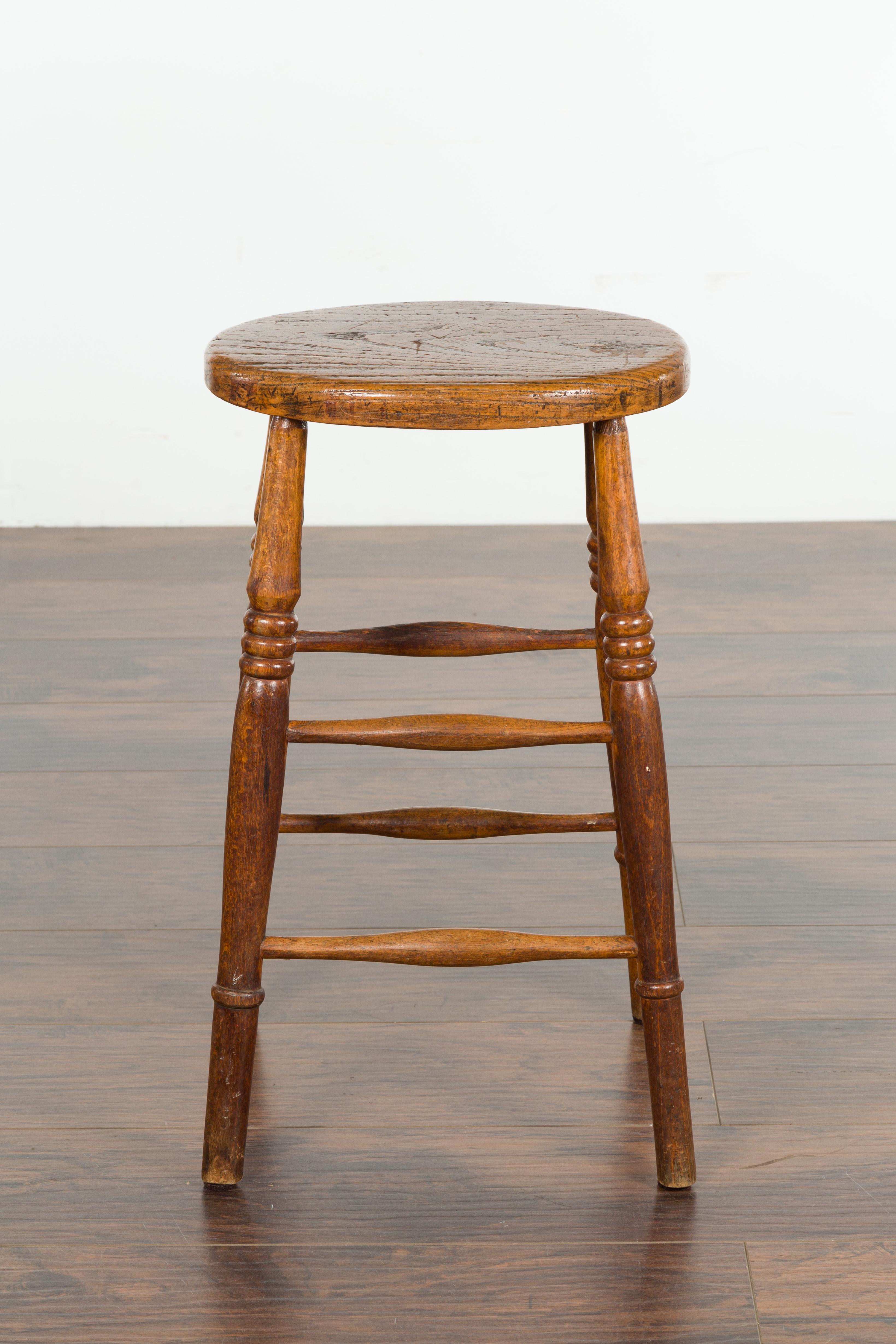 English 1880s Elm Stool with Oval Seat, Turned Splaying Legs and Side Stretchers 5